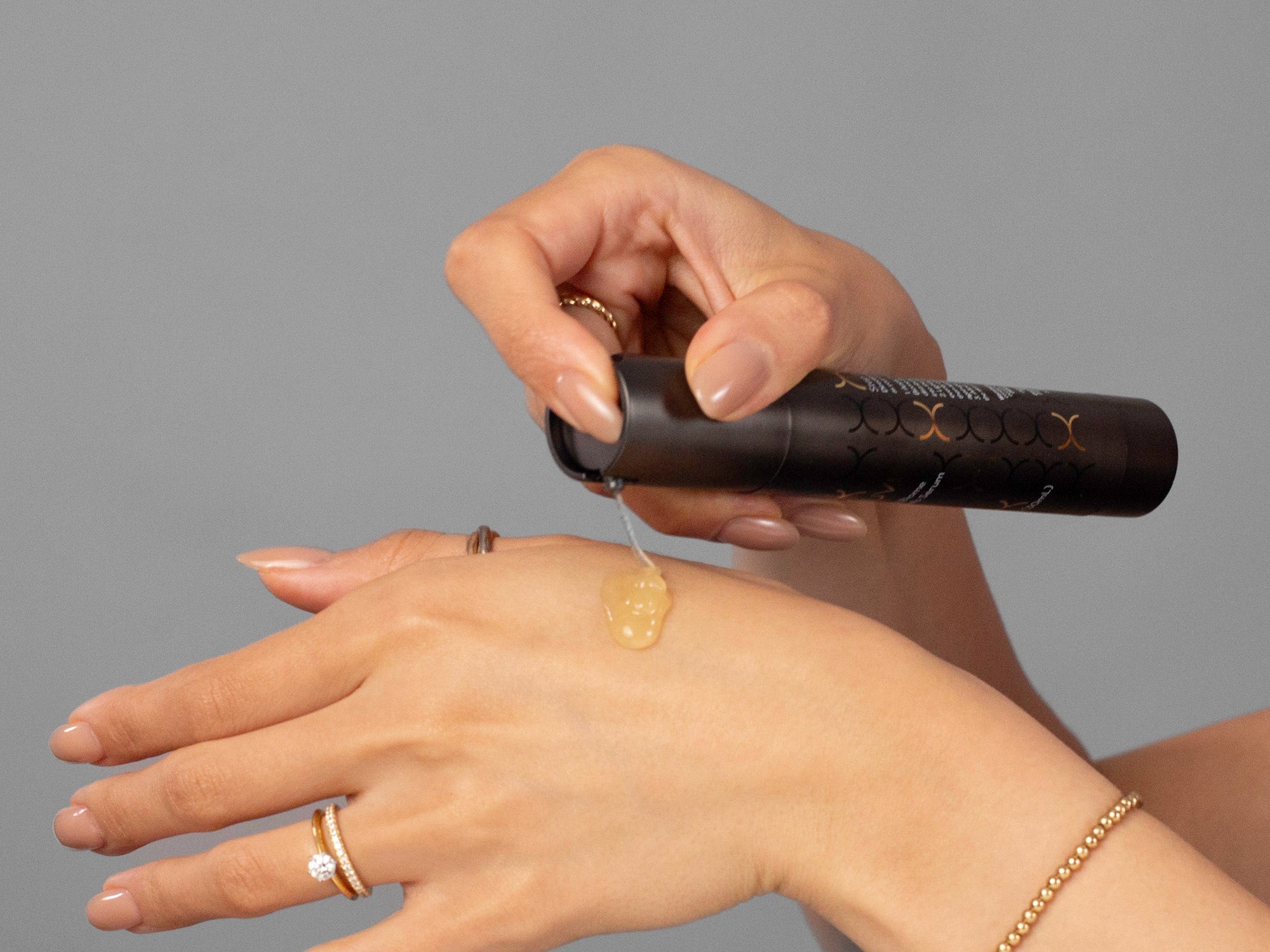 Closeup of Laziza from LAZ Skincare applying BioJuve Living Biome Essentials Serum to her hand