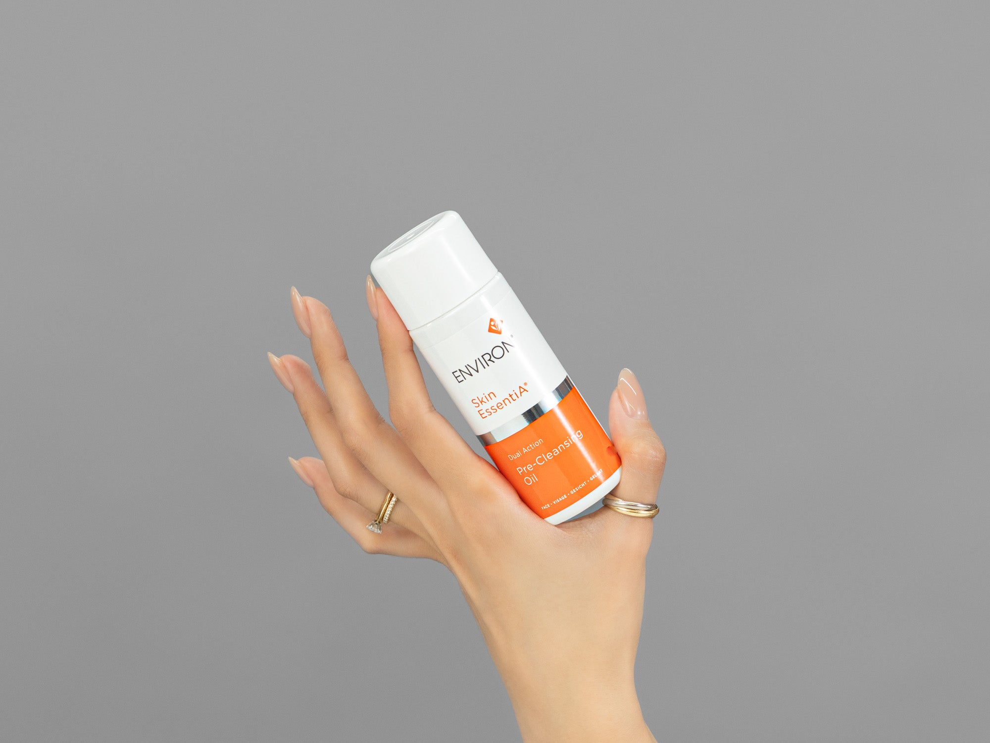 Closeup of Laziza from LAZ Skincare holding up a bottle of Environ Pre-Cleansing Oil