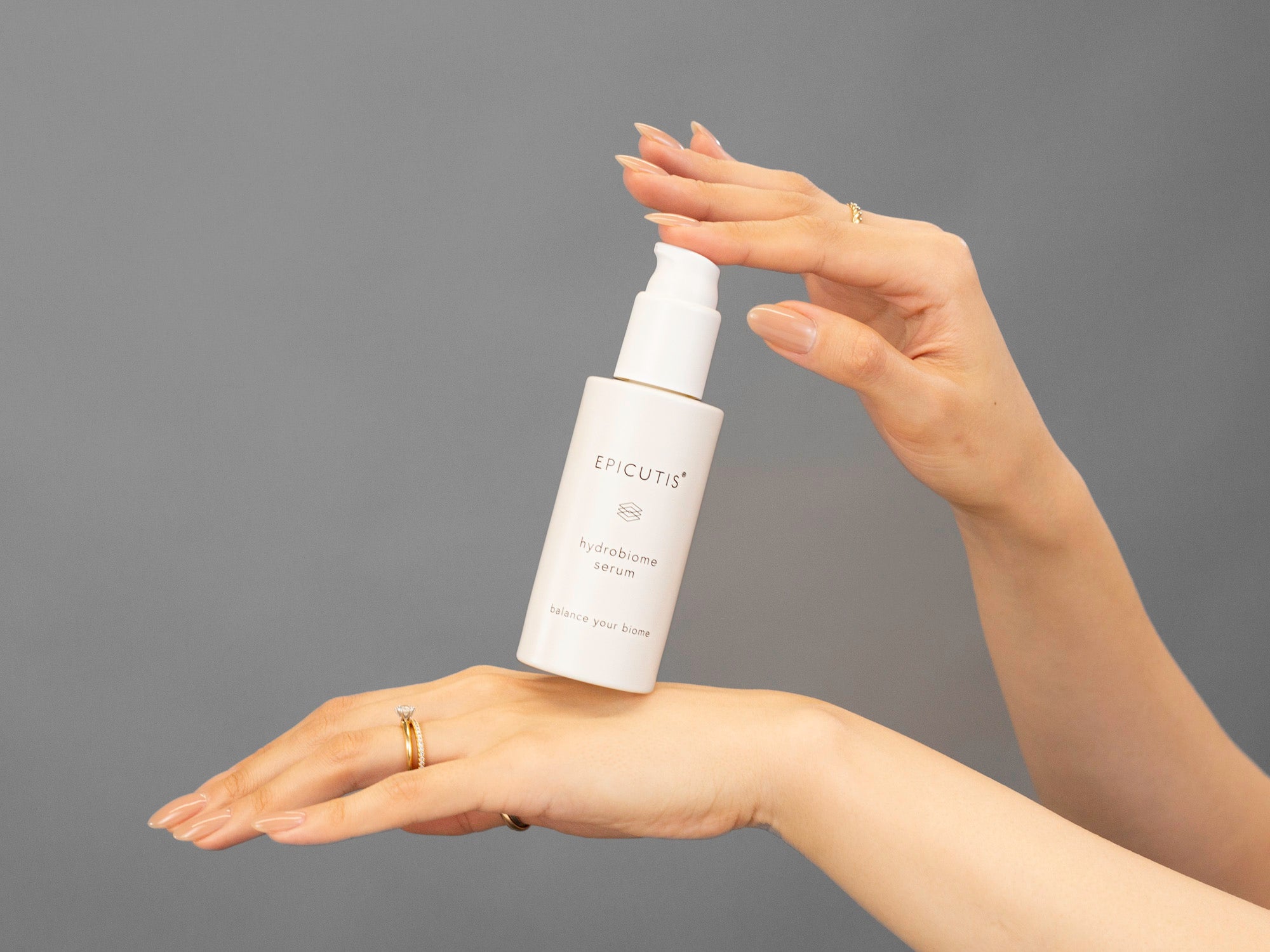 Closeup of Laziza from LAZ Skincare holding up a bottle of Epicutis Hydrobiome Serum