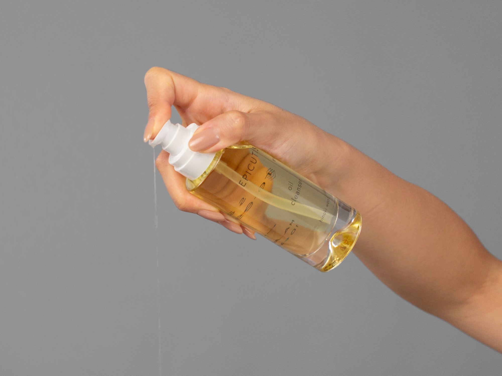 Closeup of Laziza from LAZ Skincare holding up a bottle of Epicutis Oil Cleanser