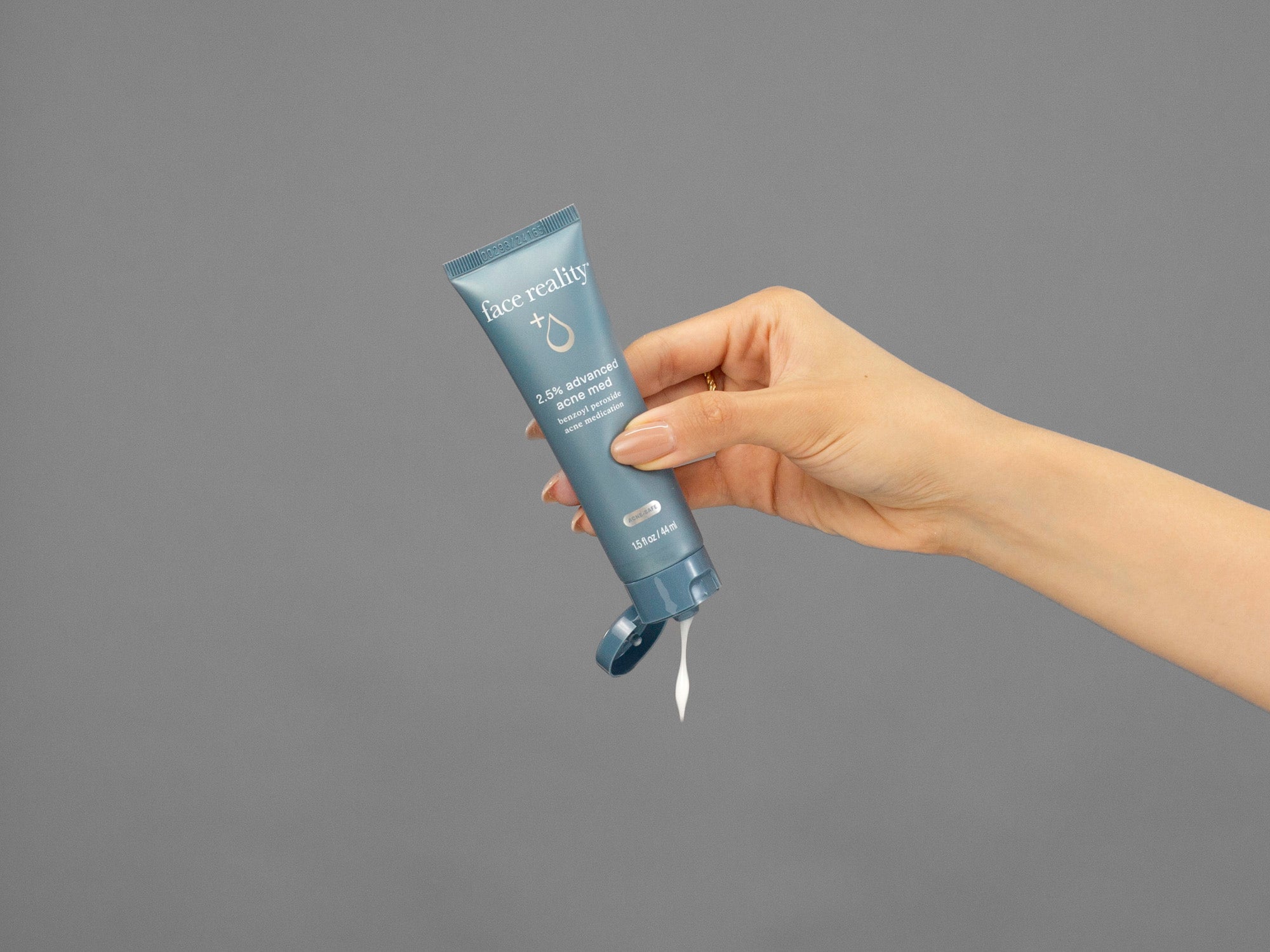 Closeup of Laziza from LAZ Skincare squeezing a tube of Face Reality Advanced Acne Med