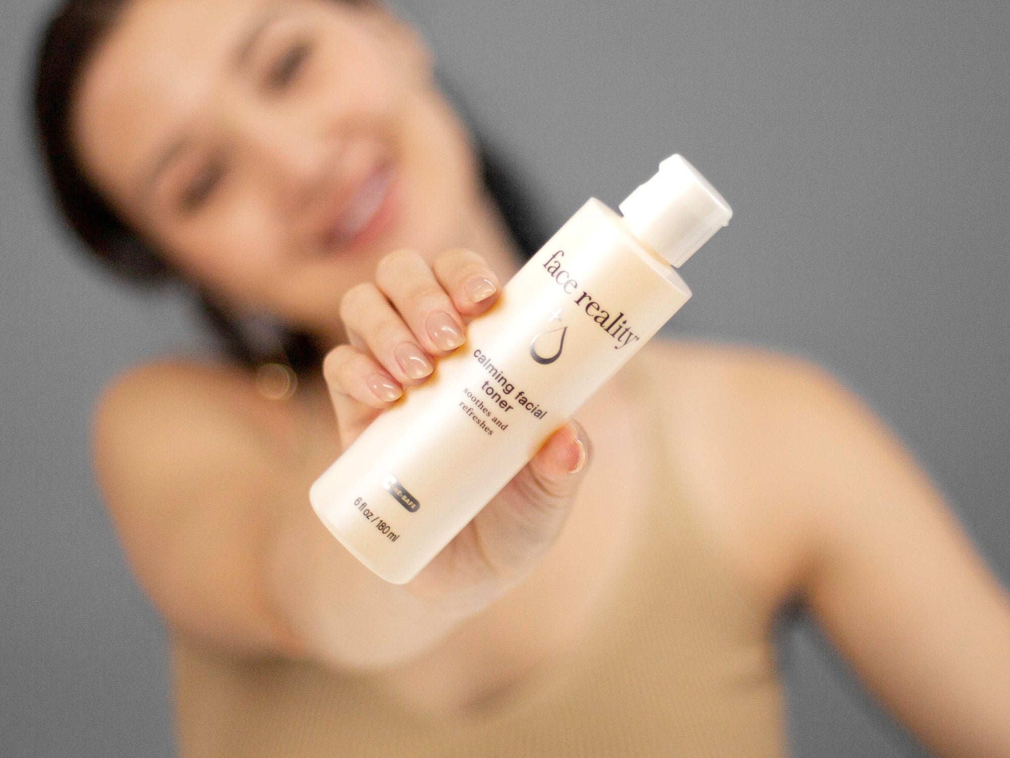 Laziza from LAZ Skincare demonstrating the texture and application of Face Reality Calming Facial Toner on her hand