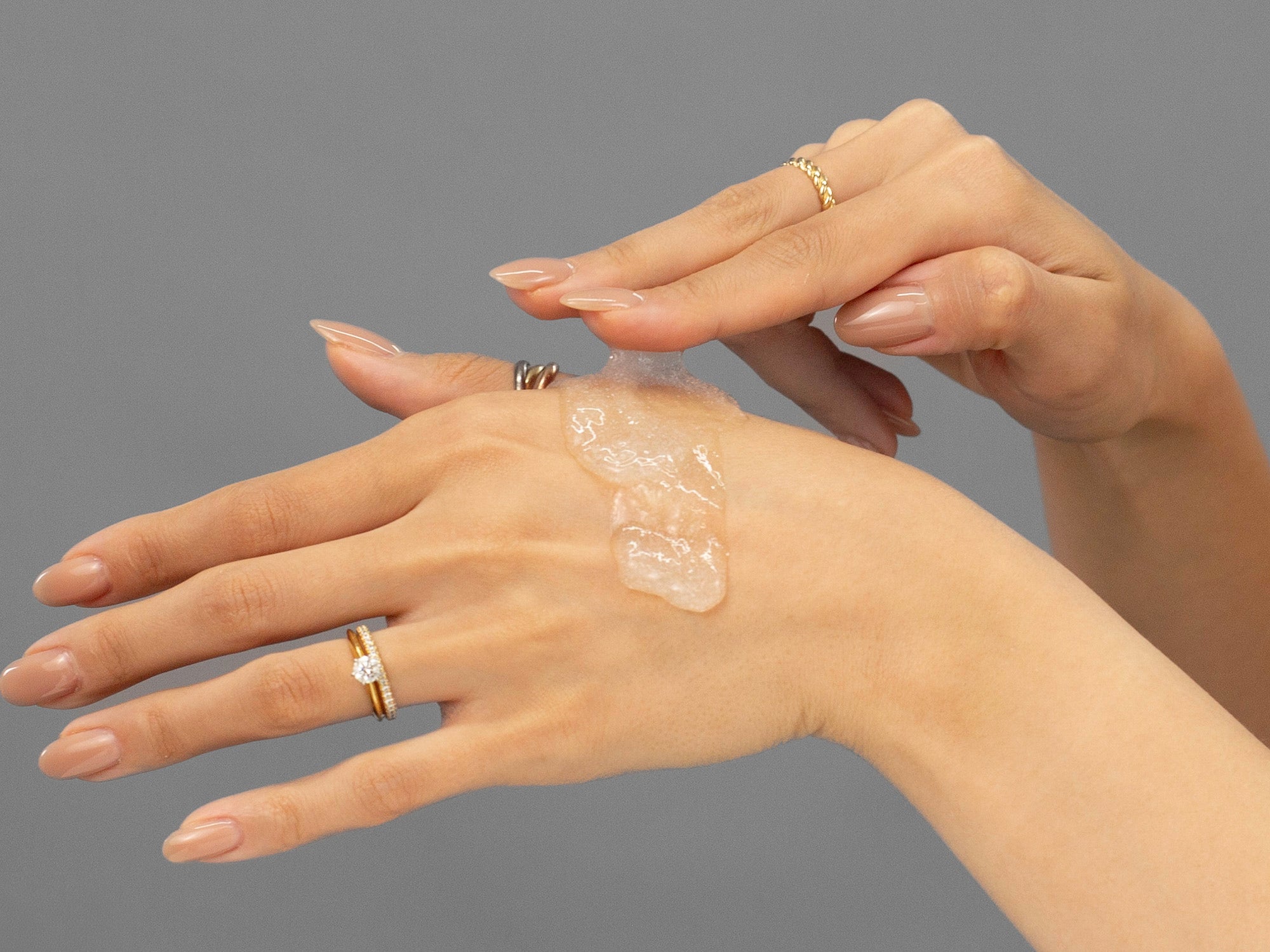 Closeup of Laziza from LAZ Skincare applying Face Reality Mandelic Face & Body Scrub to her hand