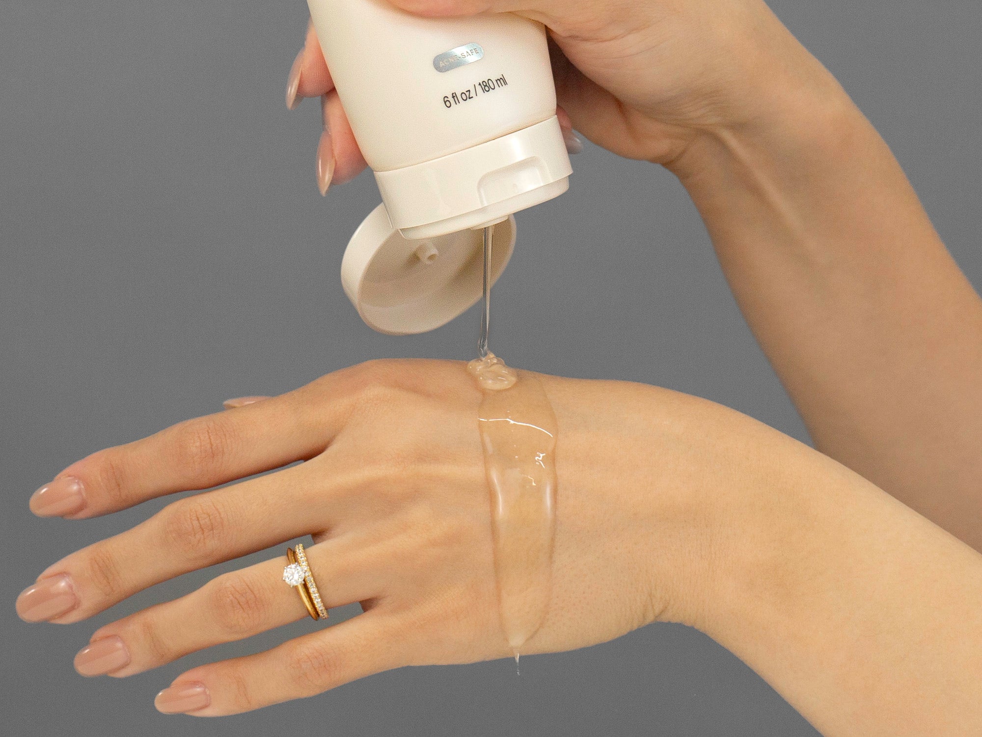 Laziza from LAZ Skincare demonstrating the texture and application of Face Reality Mandelic Face & Body Wash on her hand