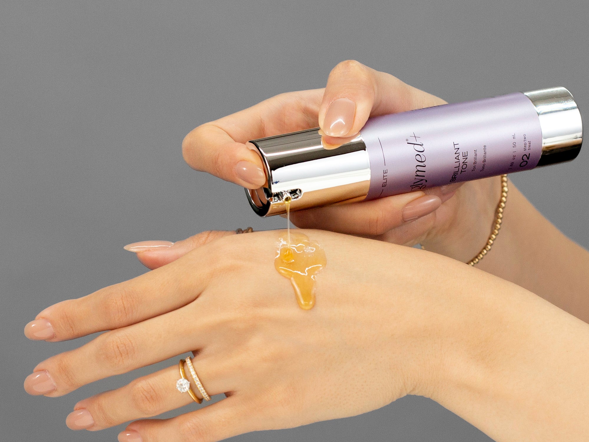 Closeup of Laziza from LAZ Skincare applying GlyMed Brilliant Tone to her hand