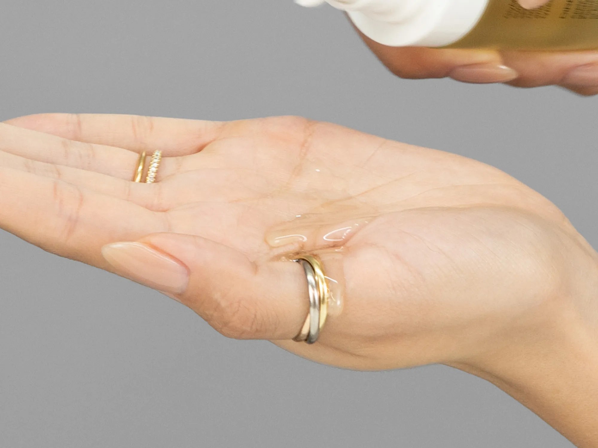 Laziza from LAZ Skincare demonstrating the texture and application of GlyMed Illuminating Cleansing Oil on her hand