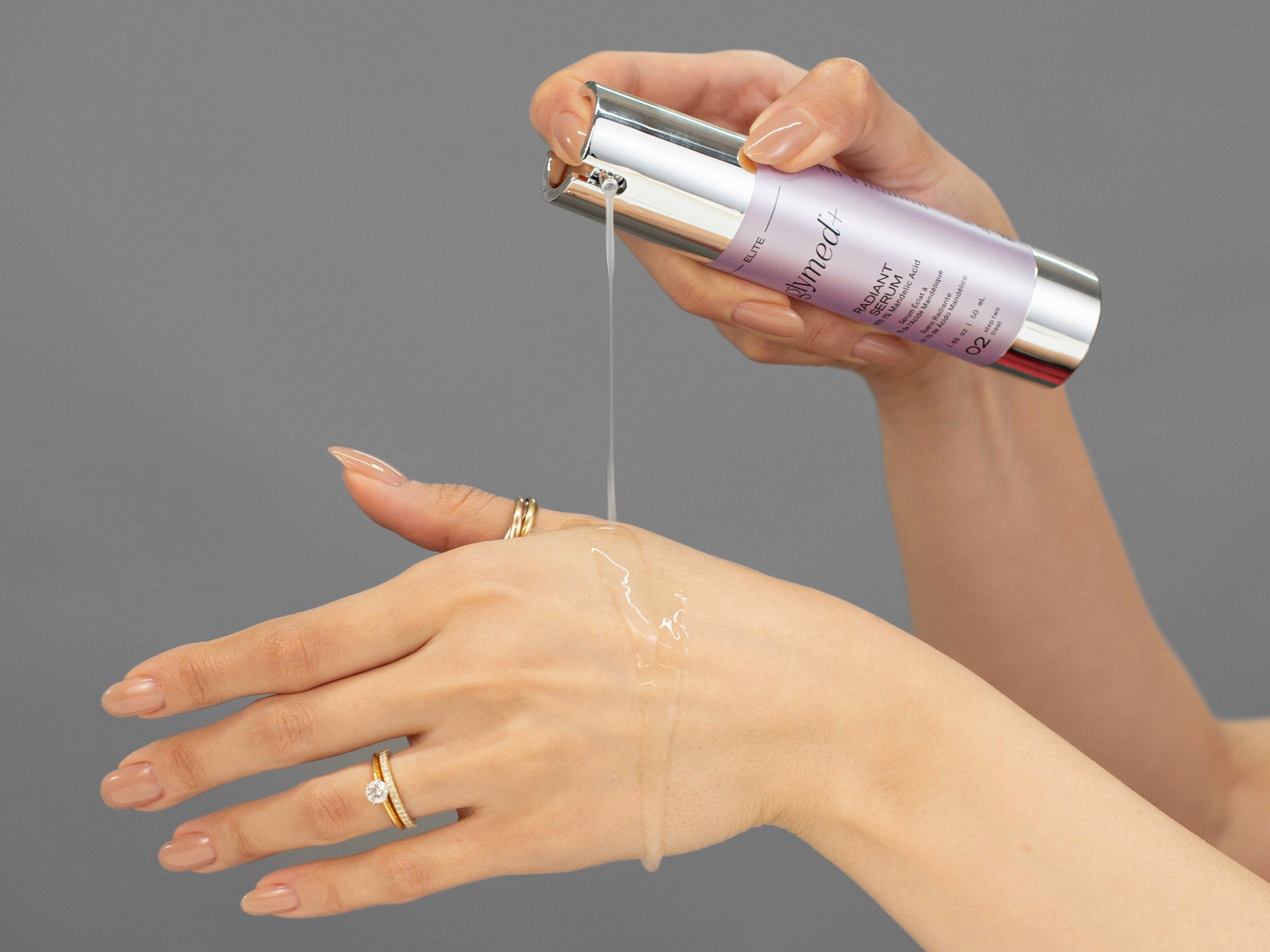 Laziza from LAZ Skincare demonstrating the texture and application of GlyMed Radiant Serum on her hand