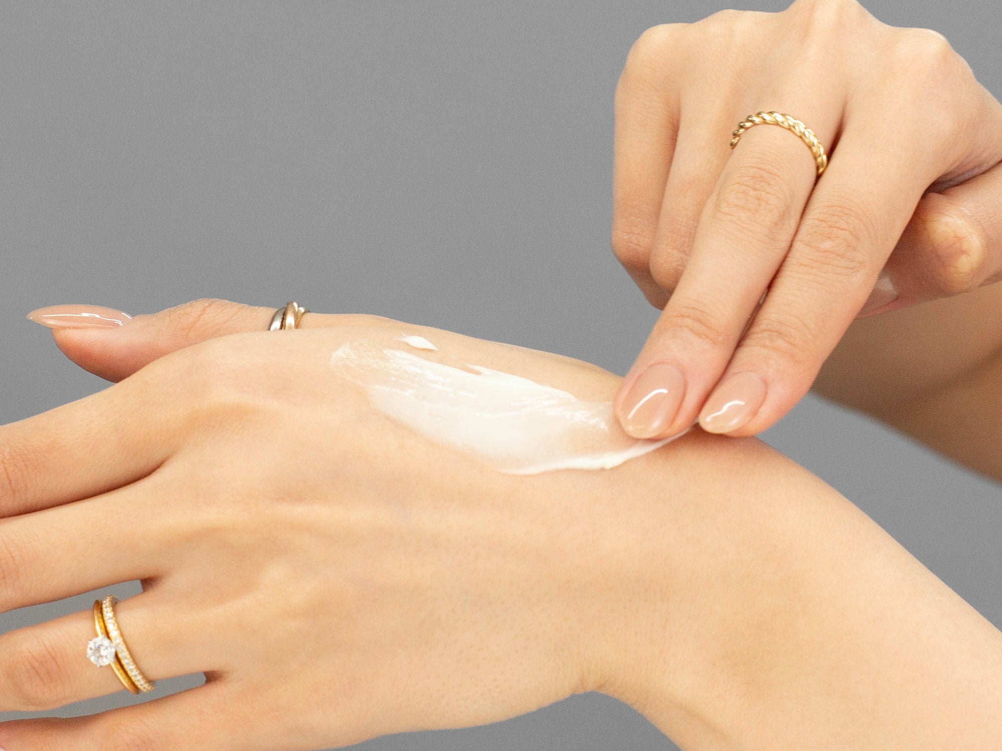 Laziza from LAZ Skincare demonstrating the texture and application of GlyMed Skin Resurfacing Lotion on her hand