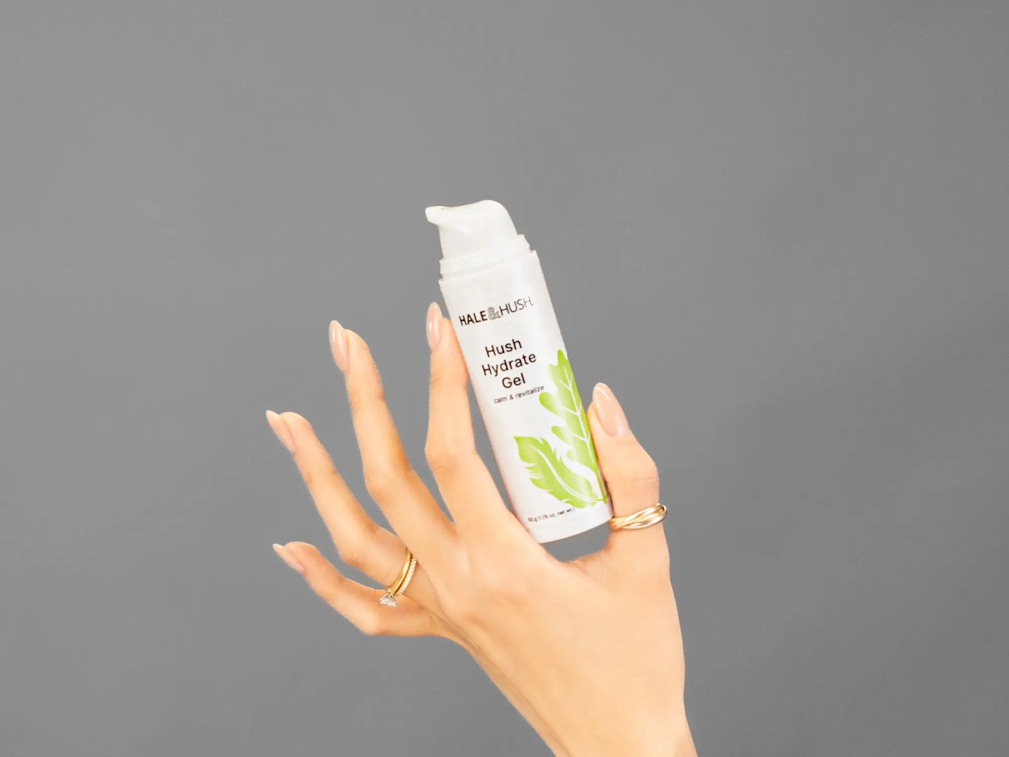 Closeup of Laziza from LAZ Skincare holding up a bottle of Hale & Hush Hush Hydrate Gel