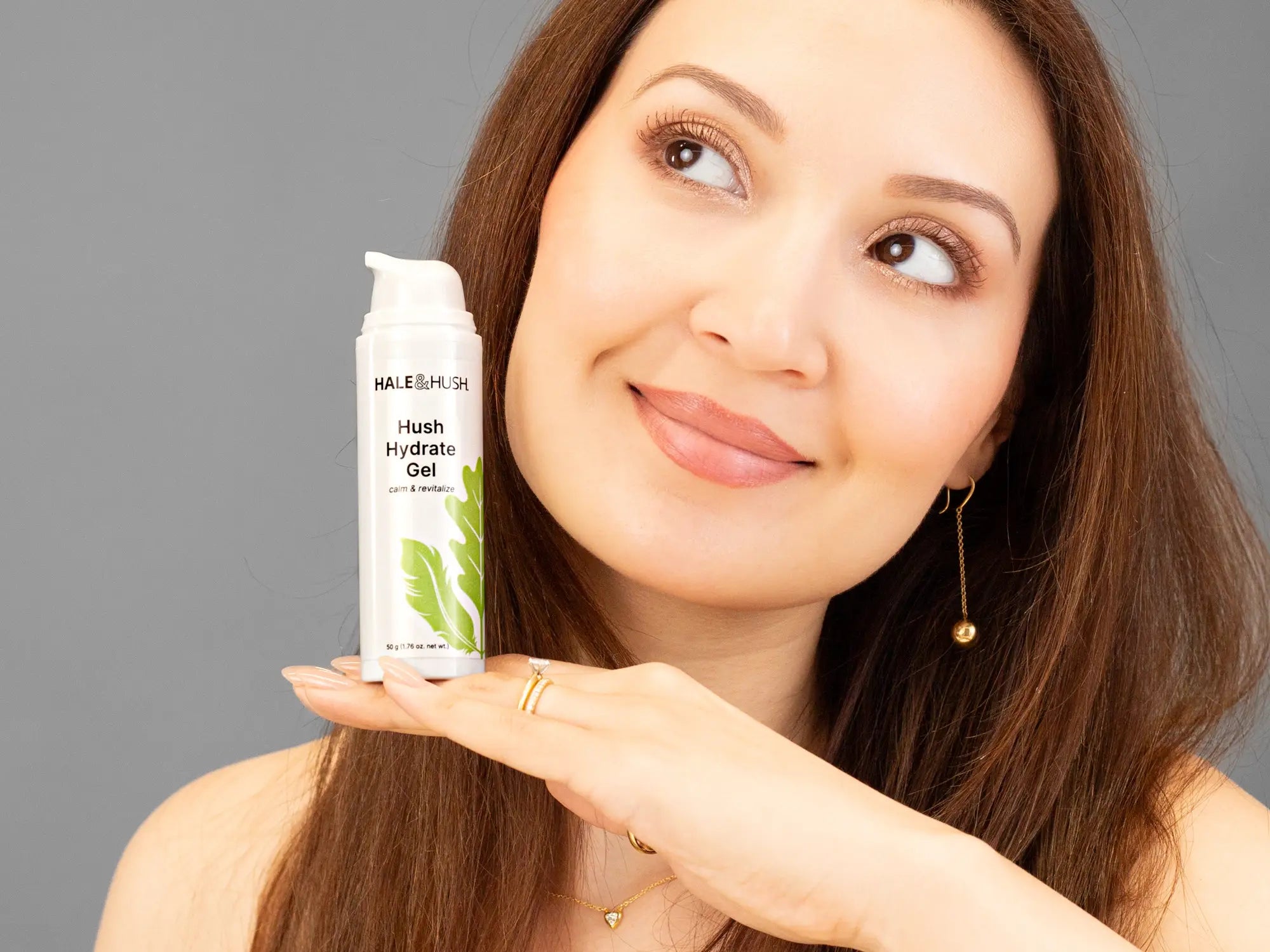 Laziza from LAZ Skincare holding a bottle of Hale & Hush Hush Hydrate Gel up to her face