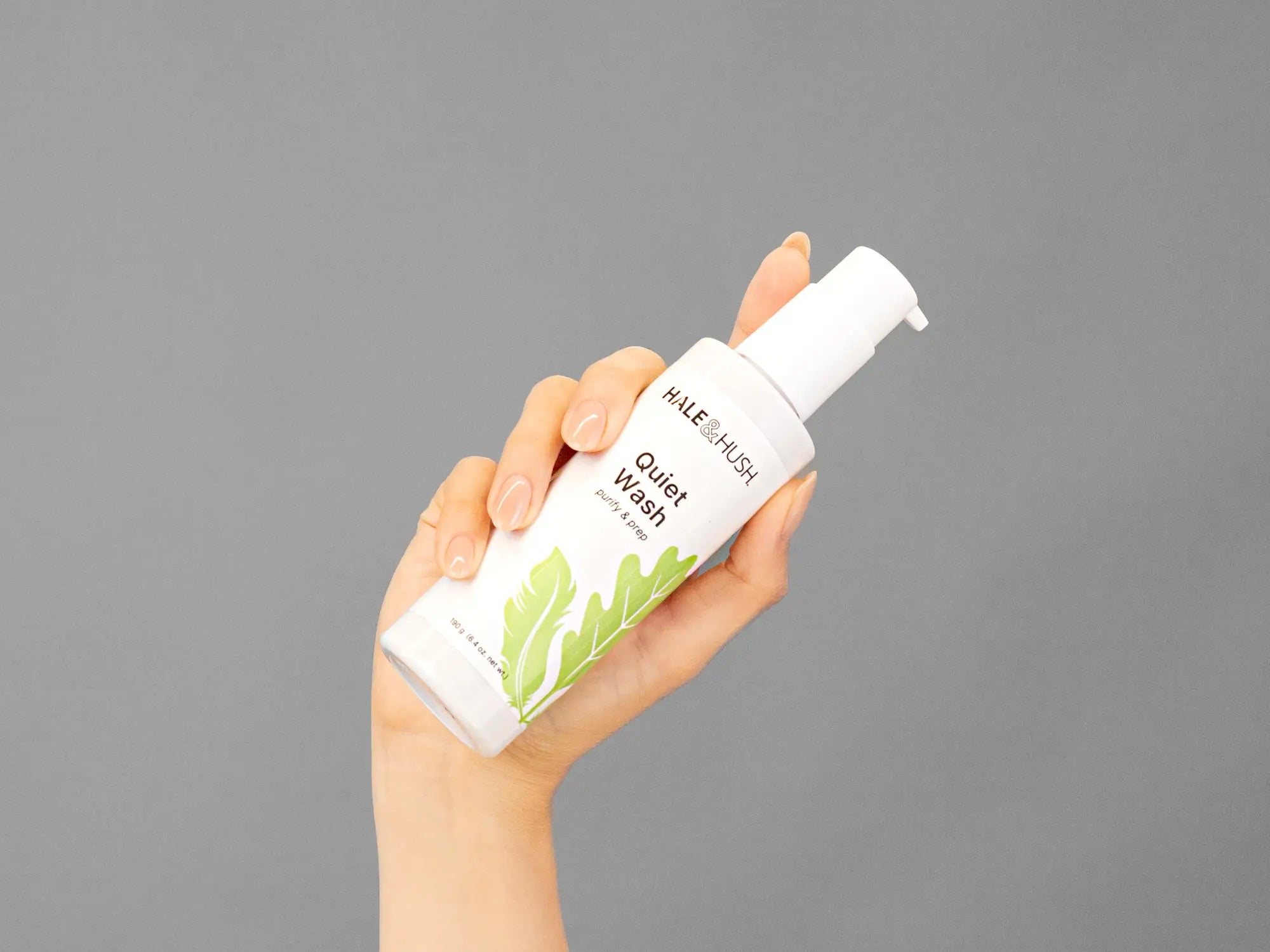 Closeup of Laziza from LAZ Skincare holding up a bottle of Hale & Hush Quiet Wash
