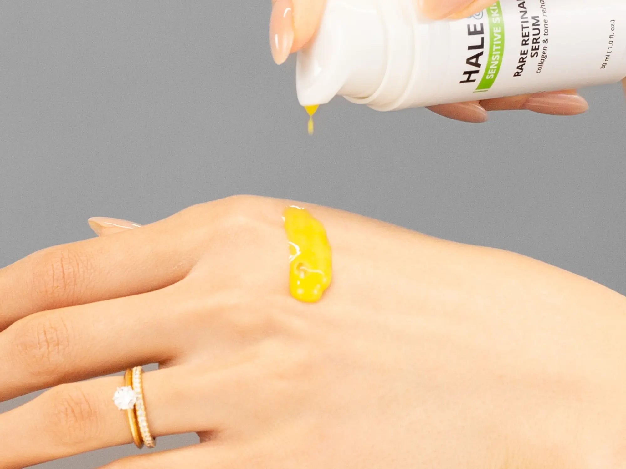 Laziza from LAZ Skincare demonstrating the texture and application of Hale & Hush Rare Retinal Serum on her hand