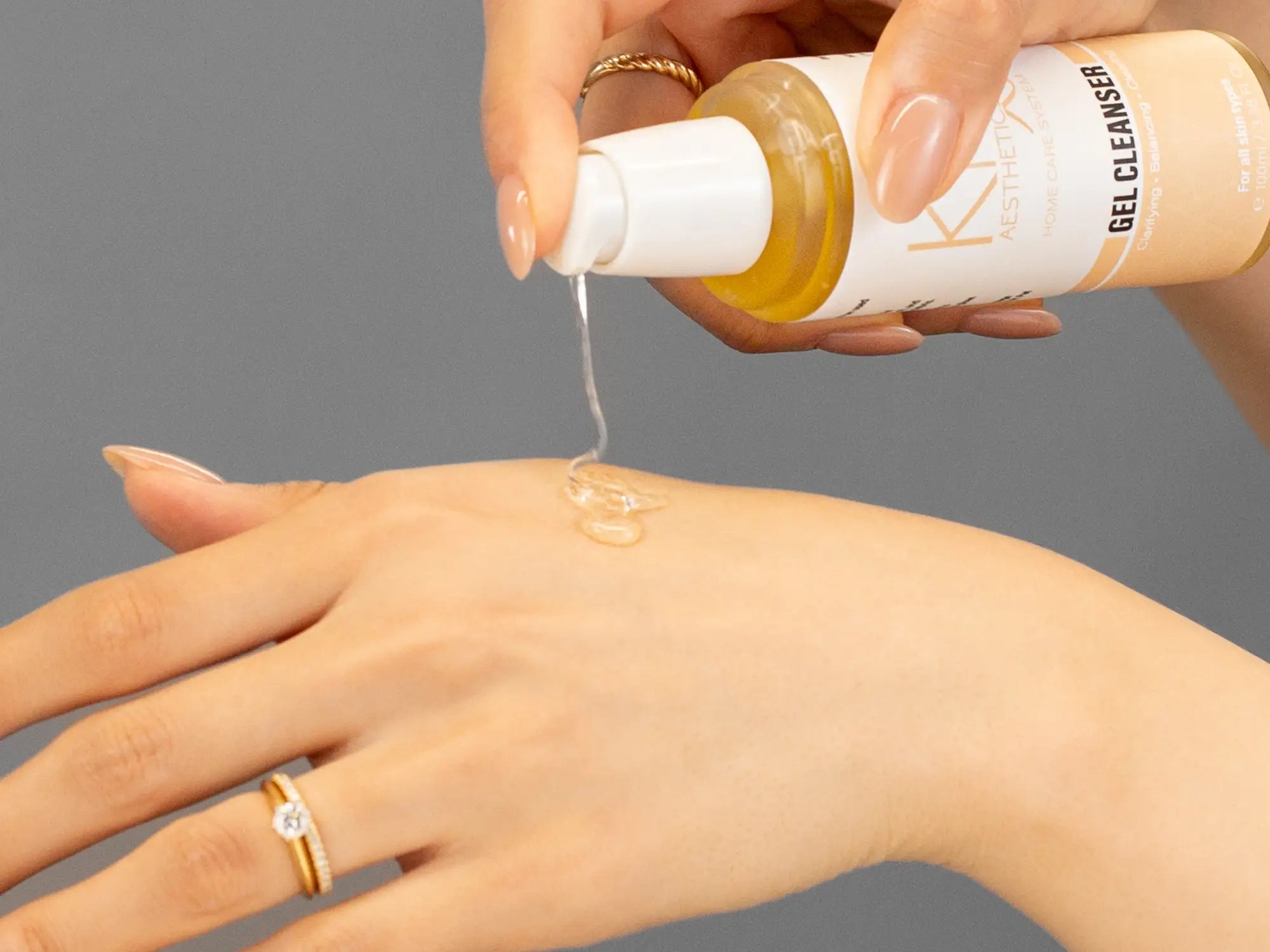 Laziza from LAZ Skincare demonstrating the texture and application of KrX Aesthetics Glow Gel Cleanser on her hand