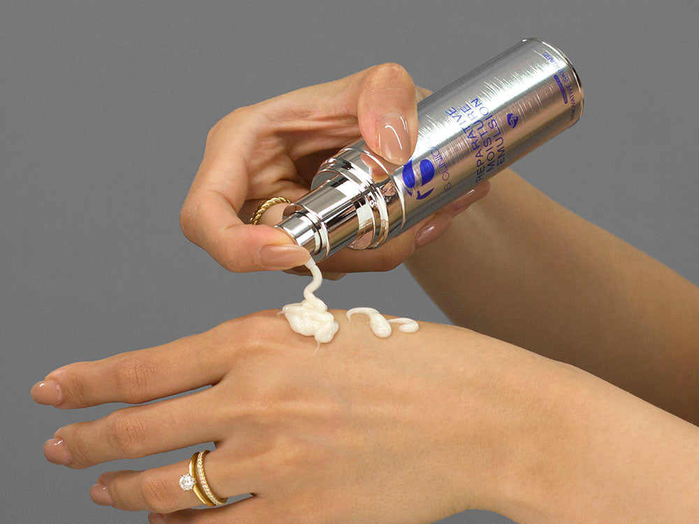 Laziza from LAZ Skincare demonstrating the texture and application of iS Clinical Reparative Moisture Emulsion on her hand