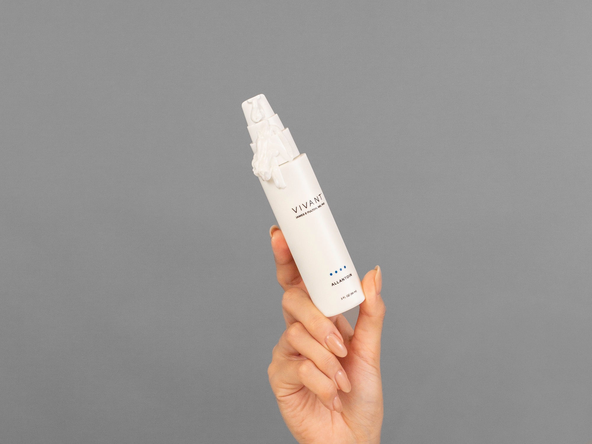 Closeup of Laziza from LAZ Skincare holding a bottle of Vivant Allantoin