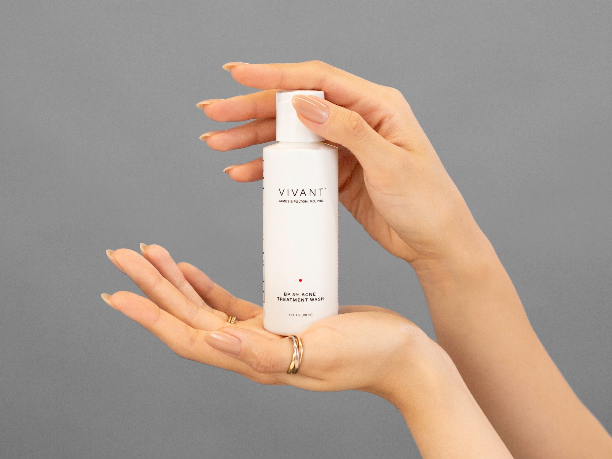 Closeup of Laziza from LAZ Skincare holding up a bottle of Vivant BP 3% Acne Wash