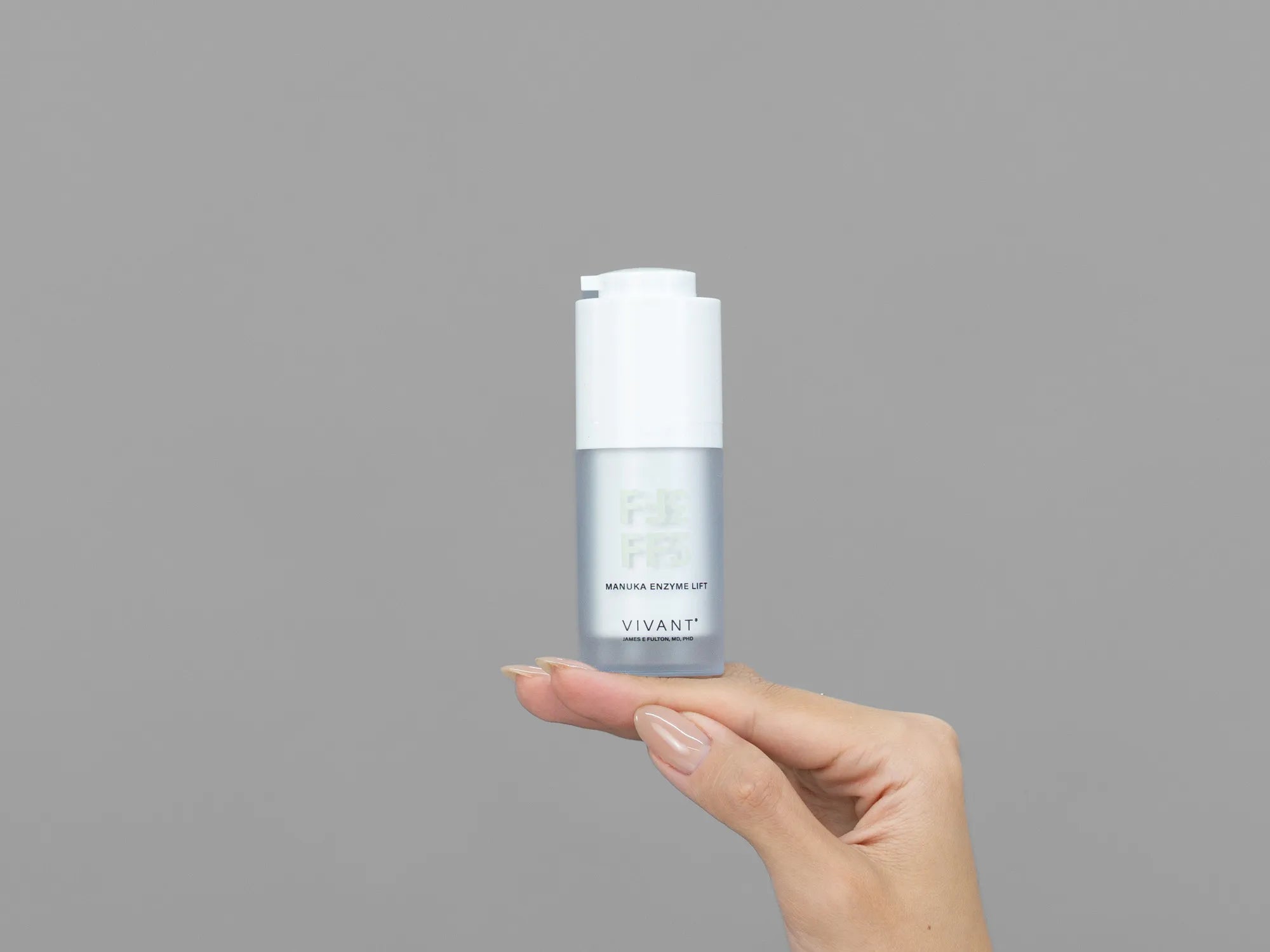 Closeup of Laziza from LAZ Skincare holding up a bottle of Vivant FF3 Manuka Enzyme Lift