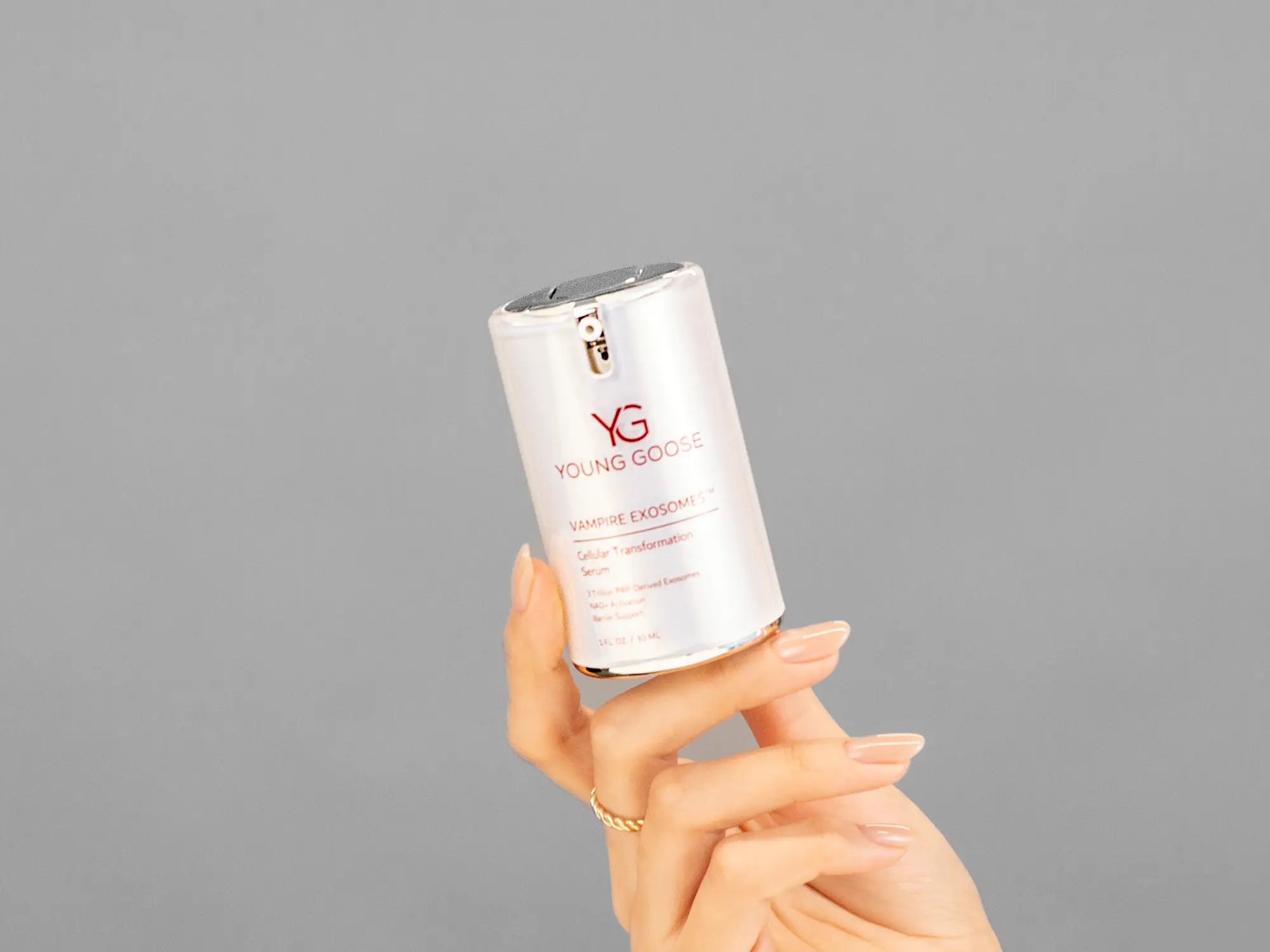 Closeup of Laziza from LAZ Skincare holding up a bottle of Young Goose Vampire Exosomes
