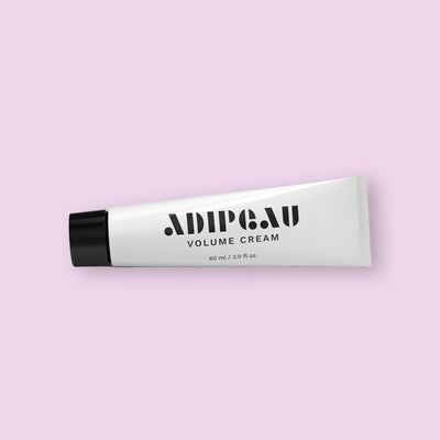 Tube of Adipeau Volume Cream on a light pink background