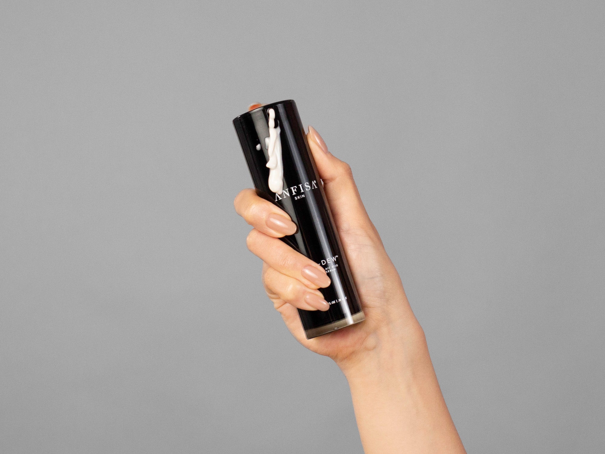 Closeup of Laziza from LAZ Skincare holding a bottle of Anfisa AN-DEW in her hand