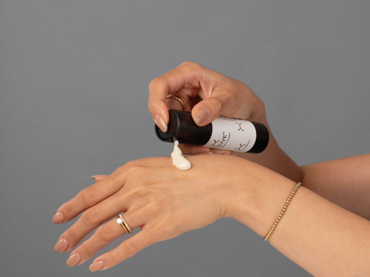 Closeup of Laziza from LAZ Skincare holding up a bottle of Biojuve Biome Support Complex