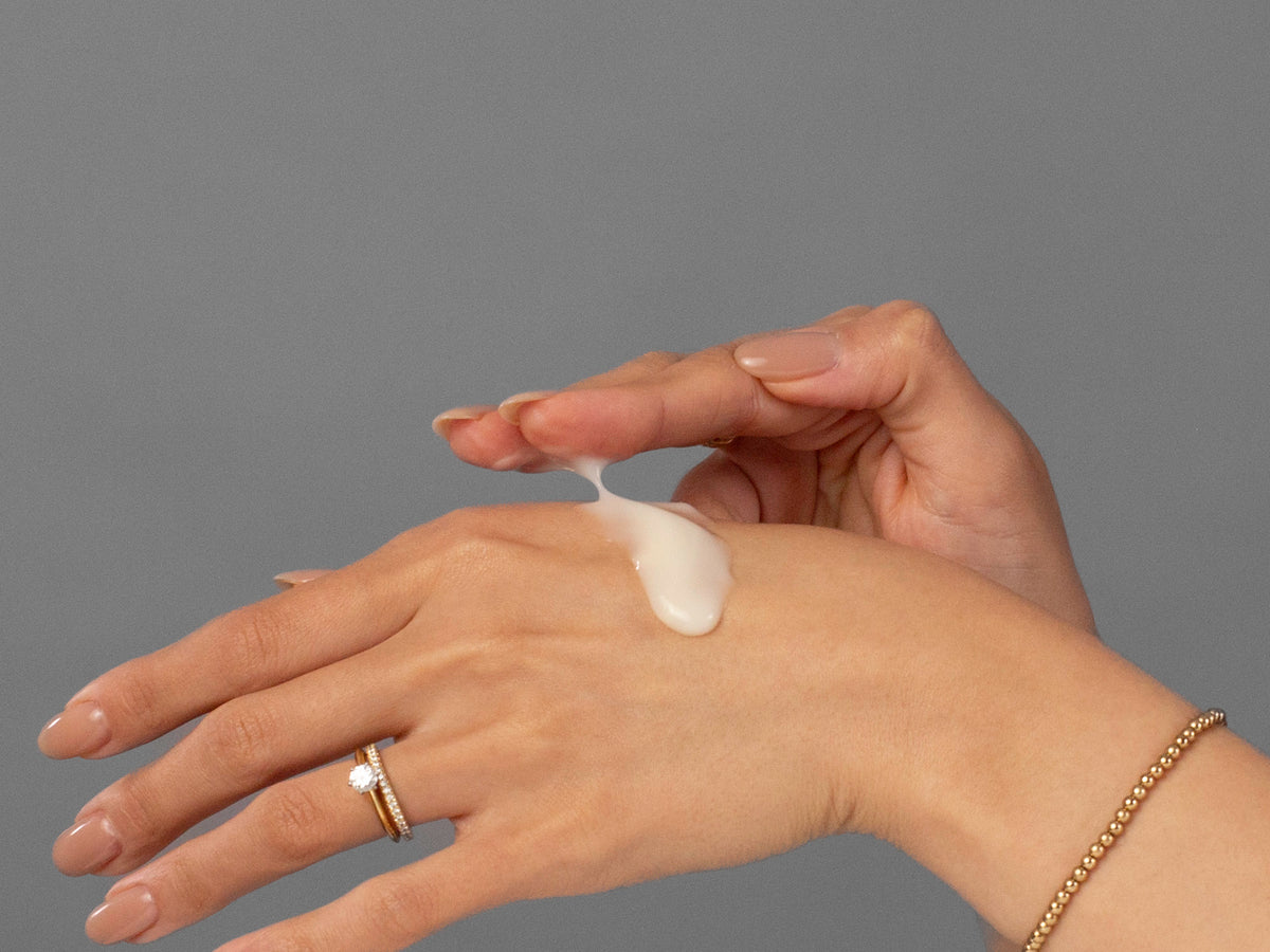 Laziza from LAZ Skincare demonstrating the texture and application of Biojuve Biome Support Complex on her hand
