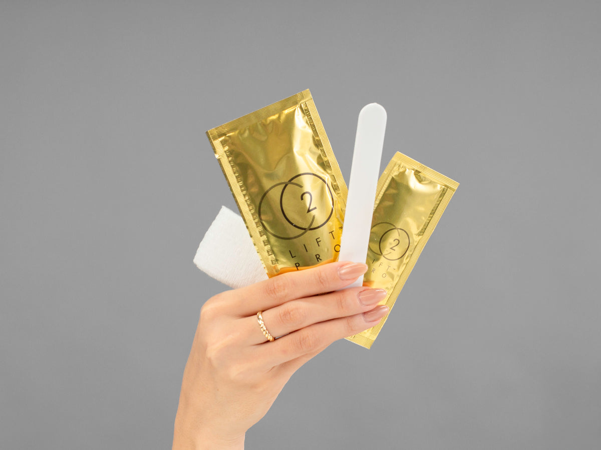 Closeup of Laziza from LAZ Skincare holding up a bottle of Lumisque CO2Lift Pro Carboxy Gel Mask