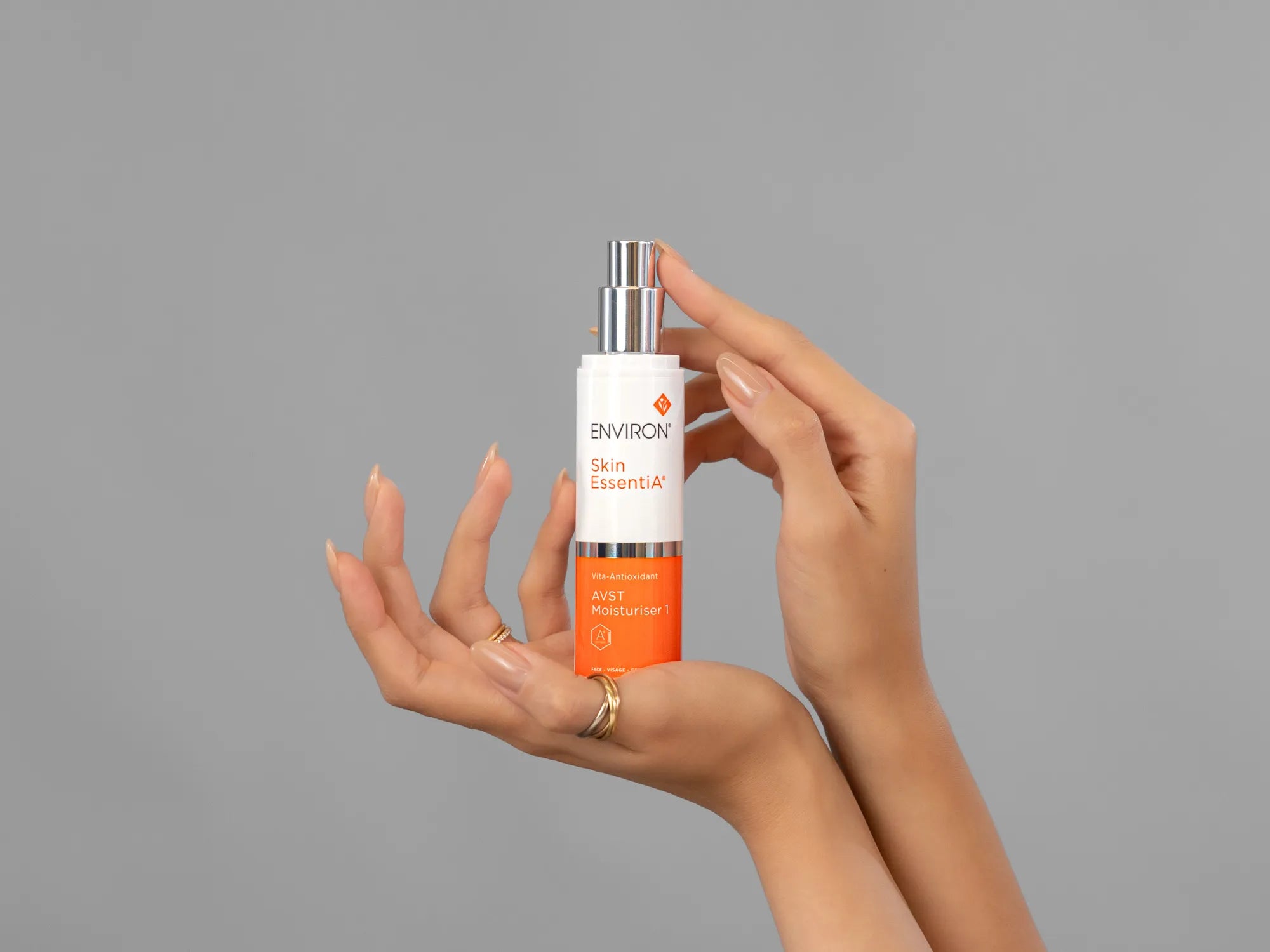 Closeup of Laziza from LAZ Skincare holding up a bottle of Environ AVST Moisturiser