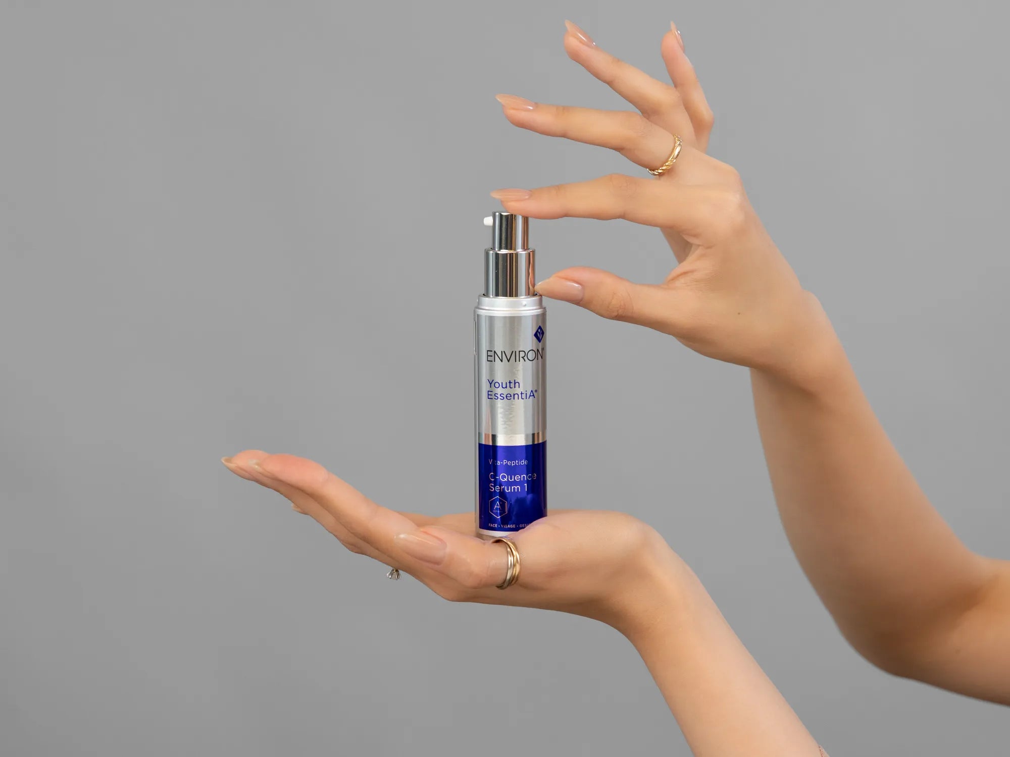 Closeup of Laziza from LAZ Skincare holding up a bottle of Environ C-Quence Serum