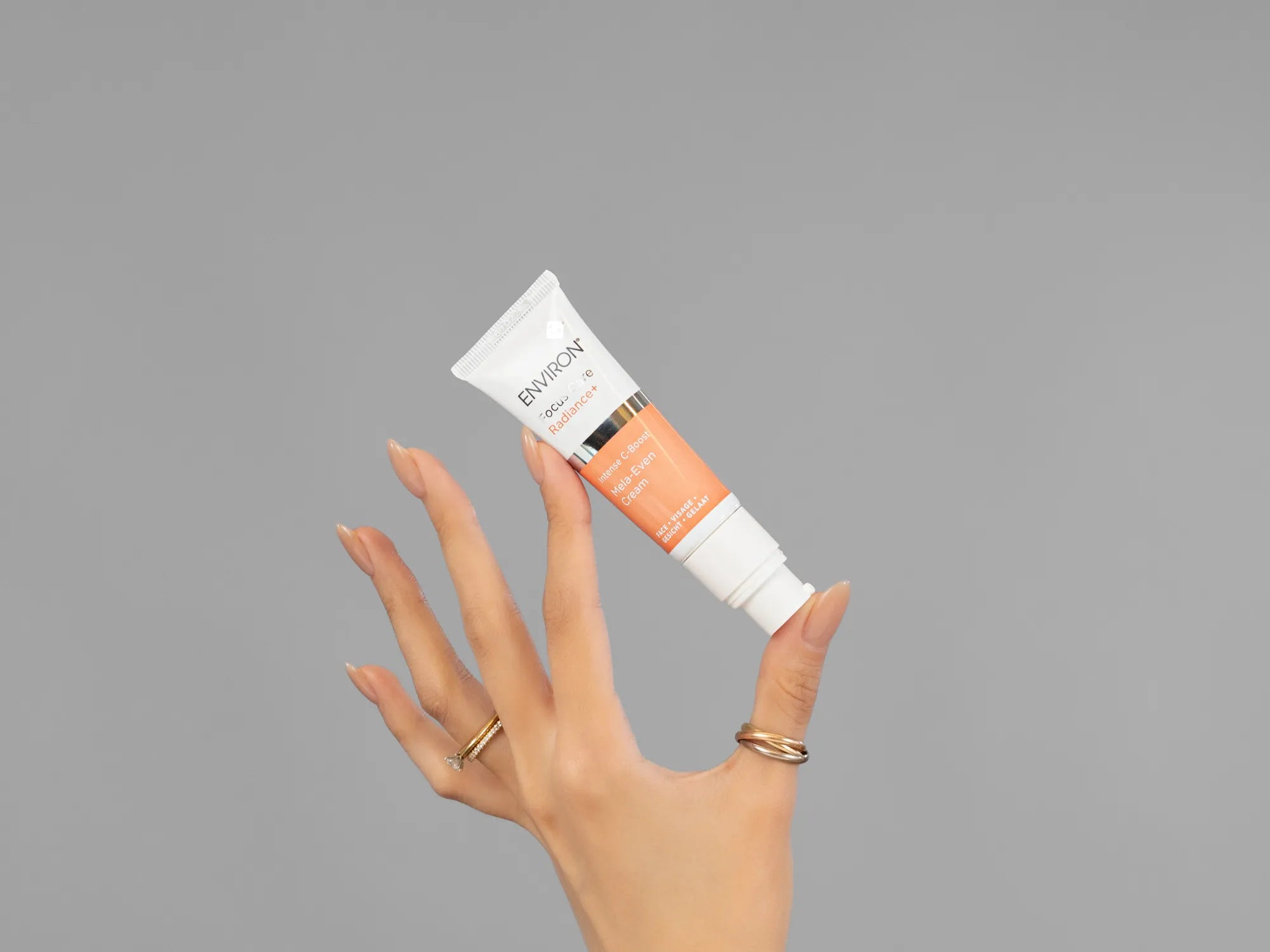 Closeup of Laziza from LAZ Skincare holding up a bottle of Environ Mela-Even Cream
