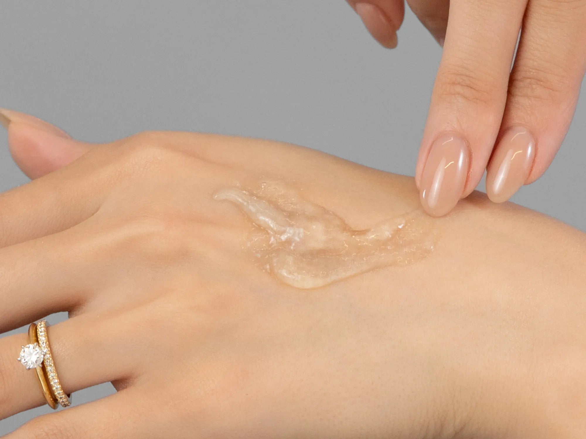Laziza from LAZ Skincare demonstrating the texture and application of Environ Sebu-Wash Gel Cleanser on her hand