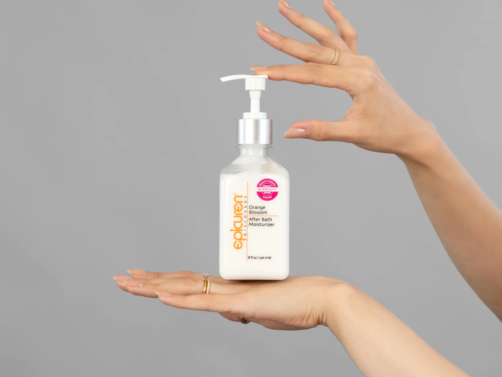 Closeup of Laziza from LAZ Skincare holding up a bottle of Epicuren After Bath Moisturizer