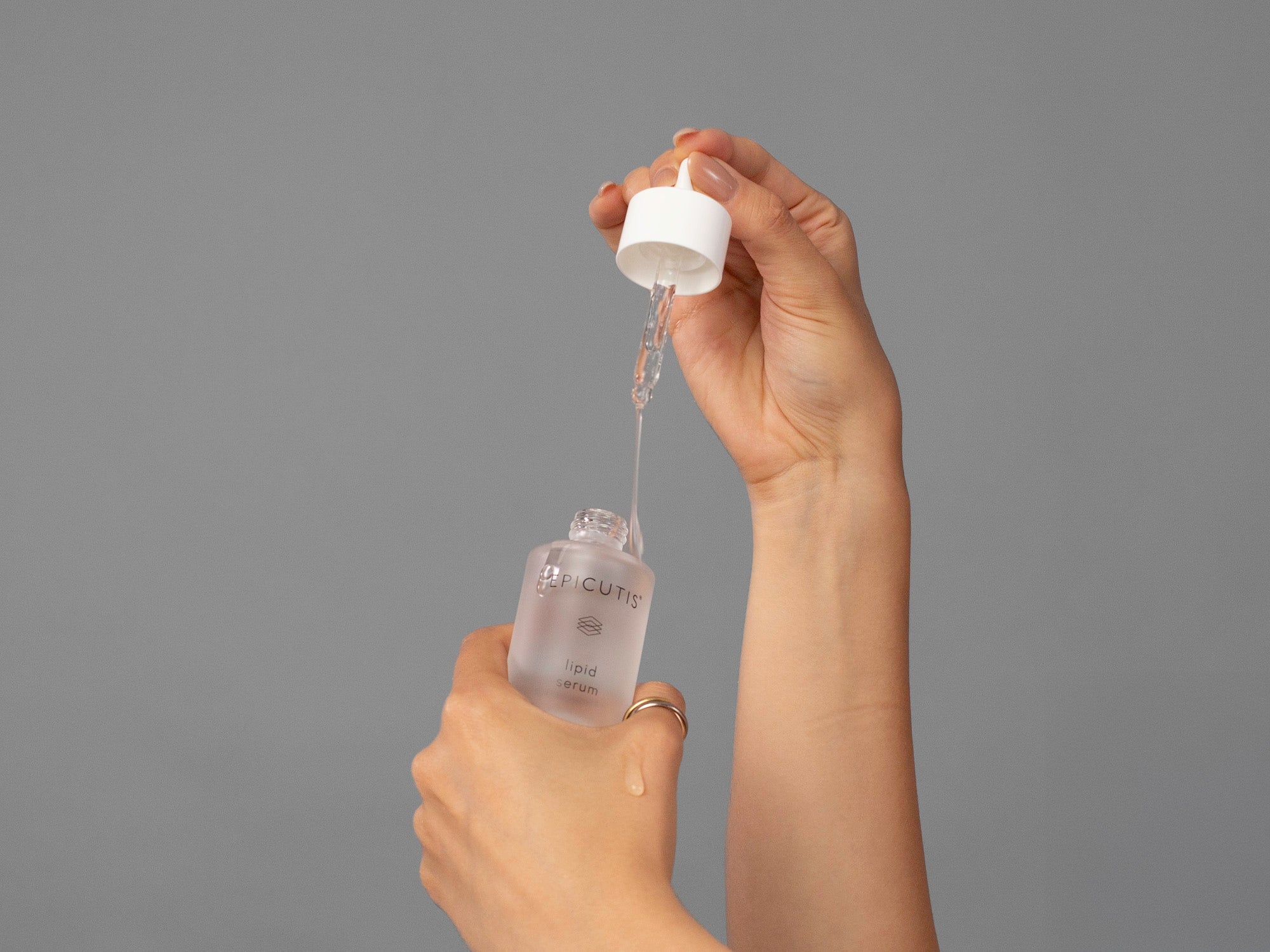 Closeup of Laziza from LAZ Skincare demonstrating the dropper and bottle of Epicutis Lipid Serum