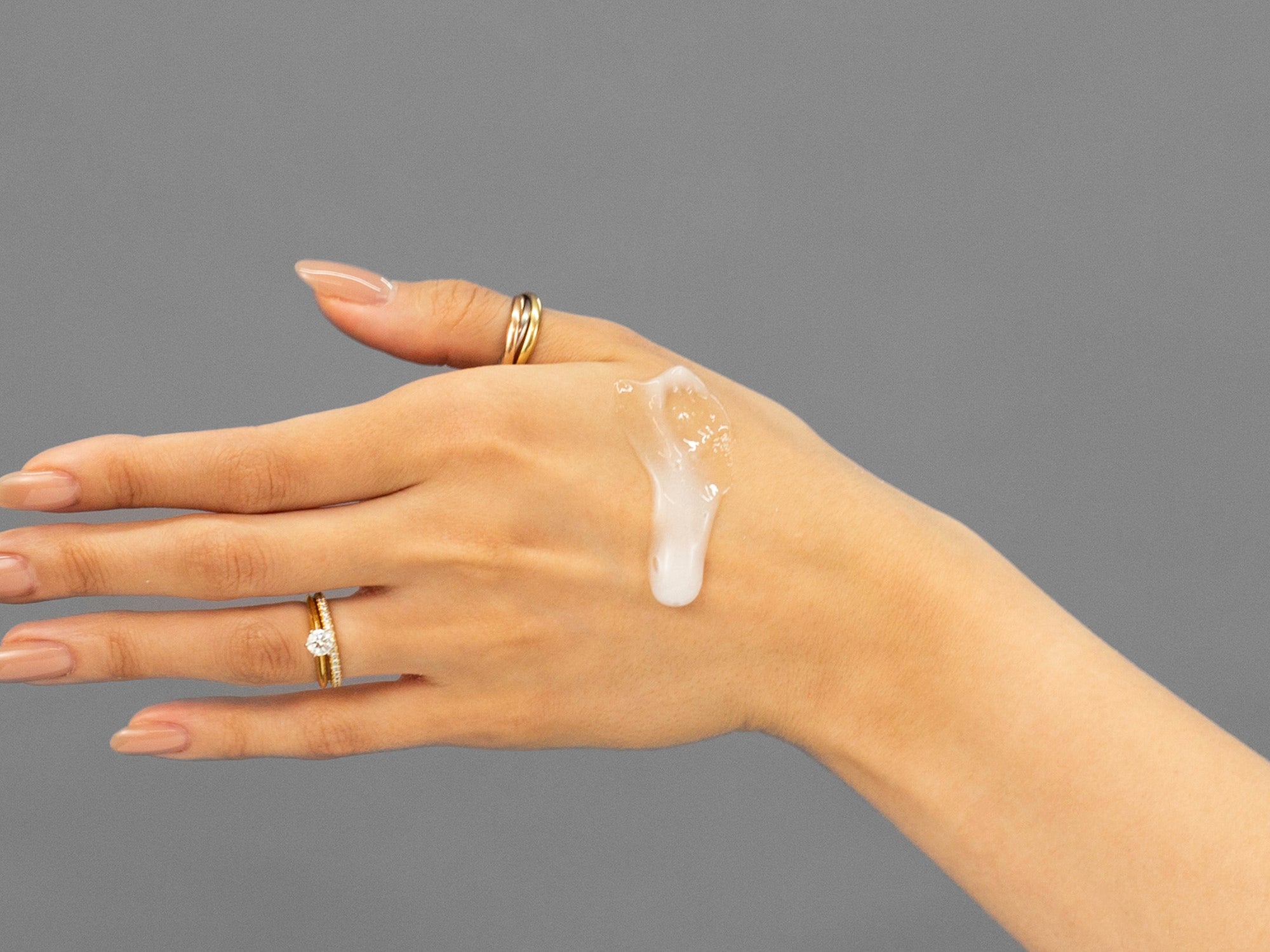 Laziza from LAZ Skincare demonstrating the texture and application of Face Reality Acne Face & Body Wash on her hand