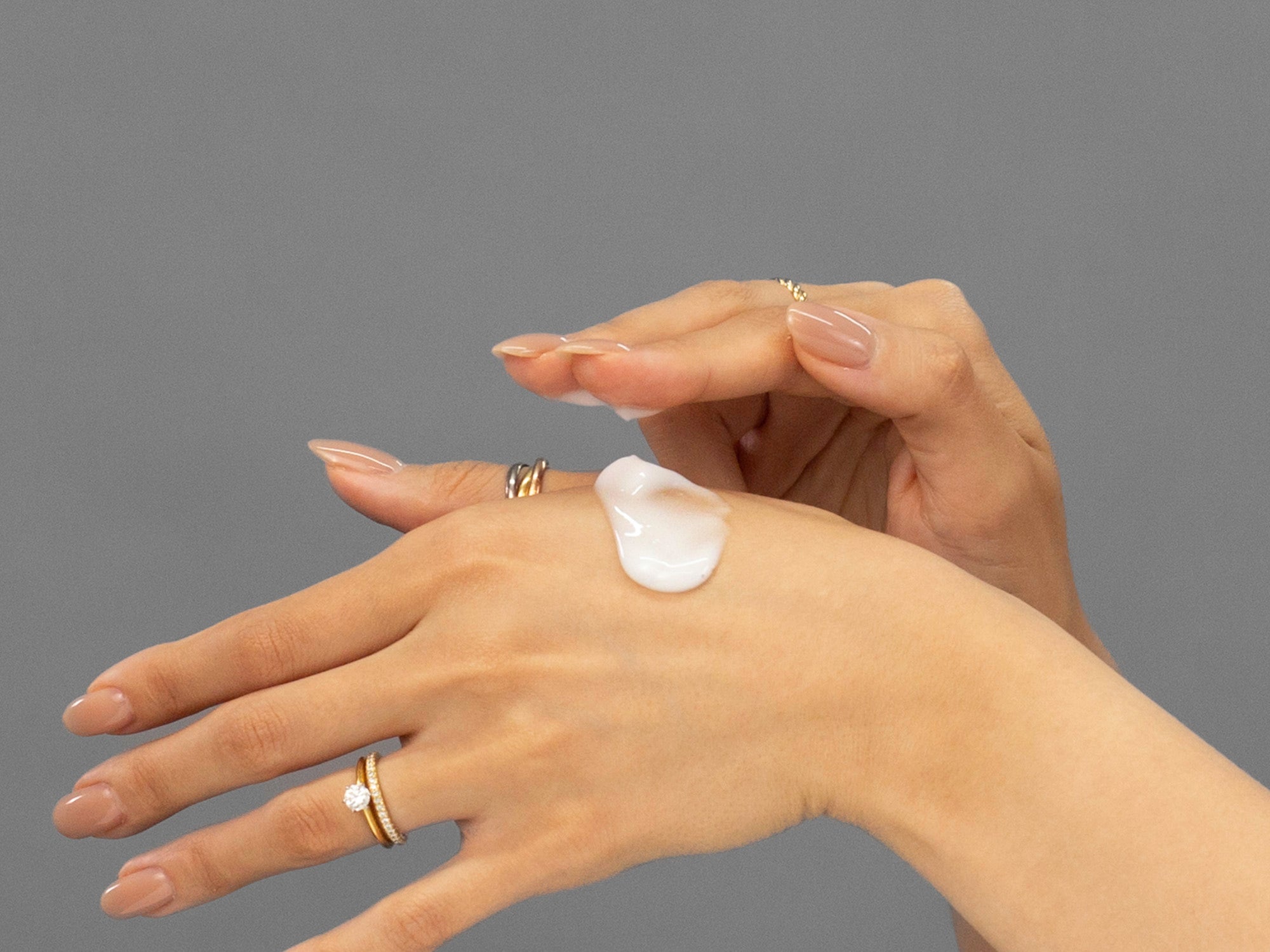 Closeup of Laziza from LAZ Skincare applying Face Reality Advanced Acne Med to her hand