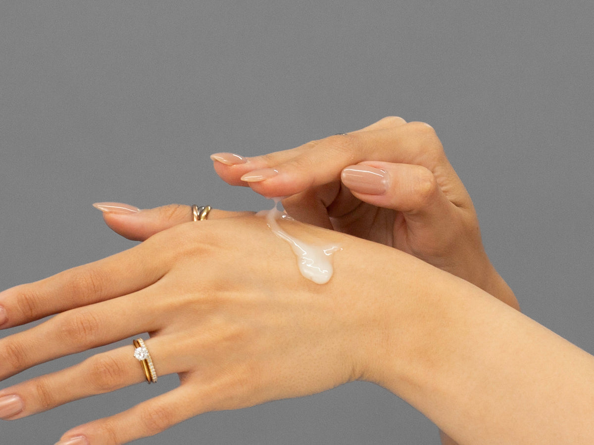 Laziza from LAZ Skincare demonstrating the texture and application of Face Reality Antioxidant Peptide Serum on her hand