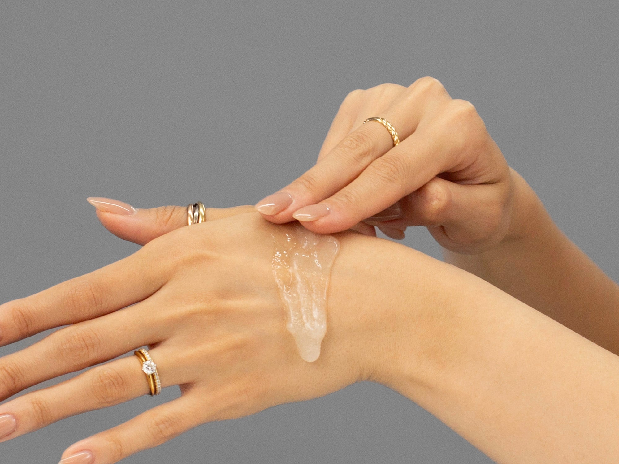Laziza from LAZ Skincare demonstrating the texture and application of Face Reality Antioxidant Scrub on her hand