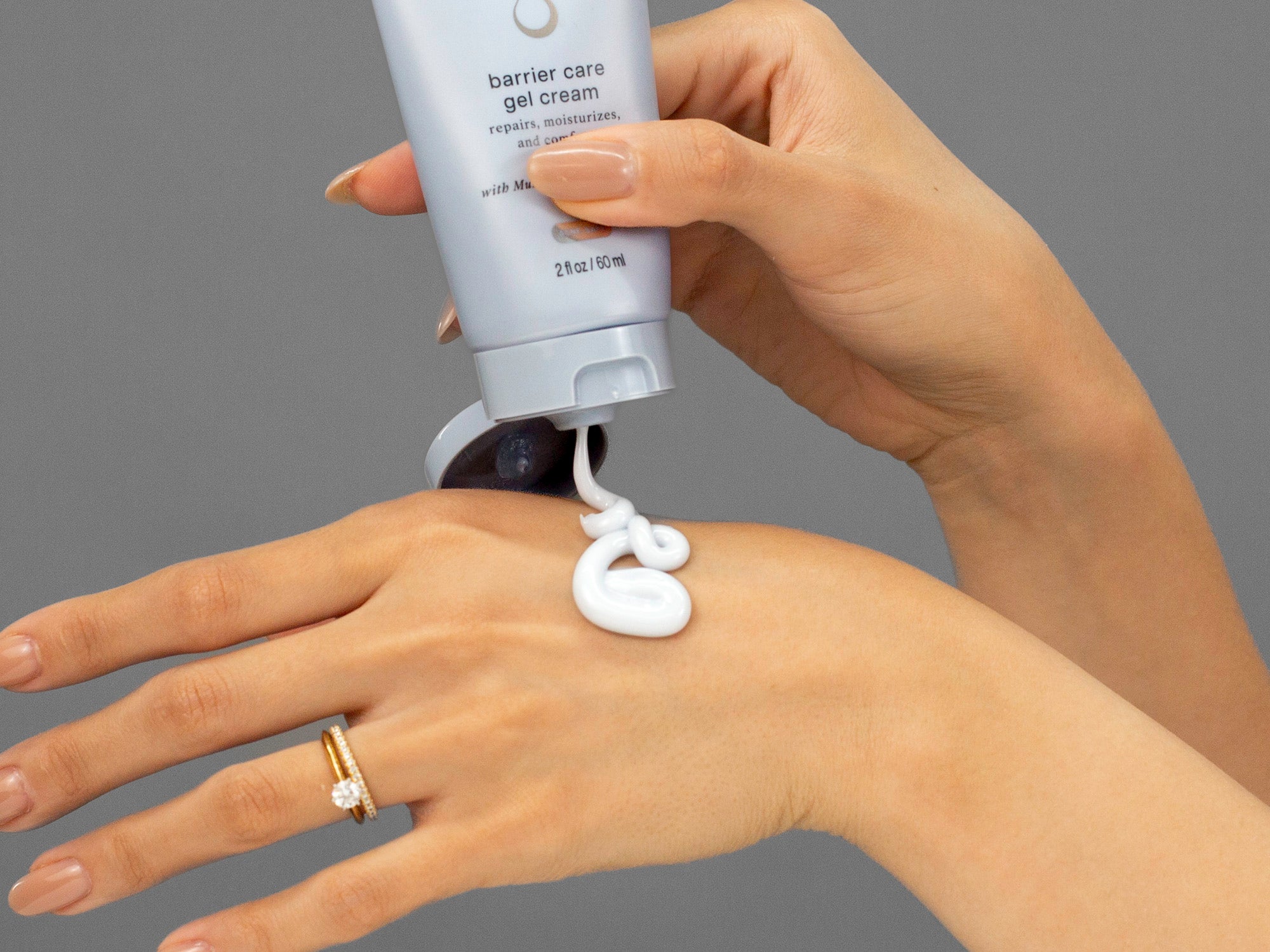 Closeup of Laziza from LAZ Skincare applying Face Reality Barrier Care Gel Cream to her hand