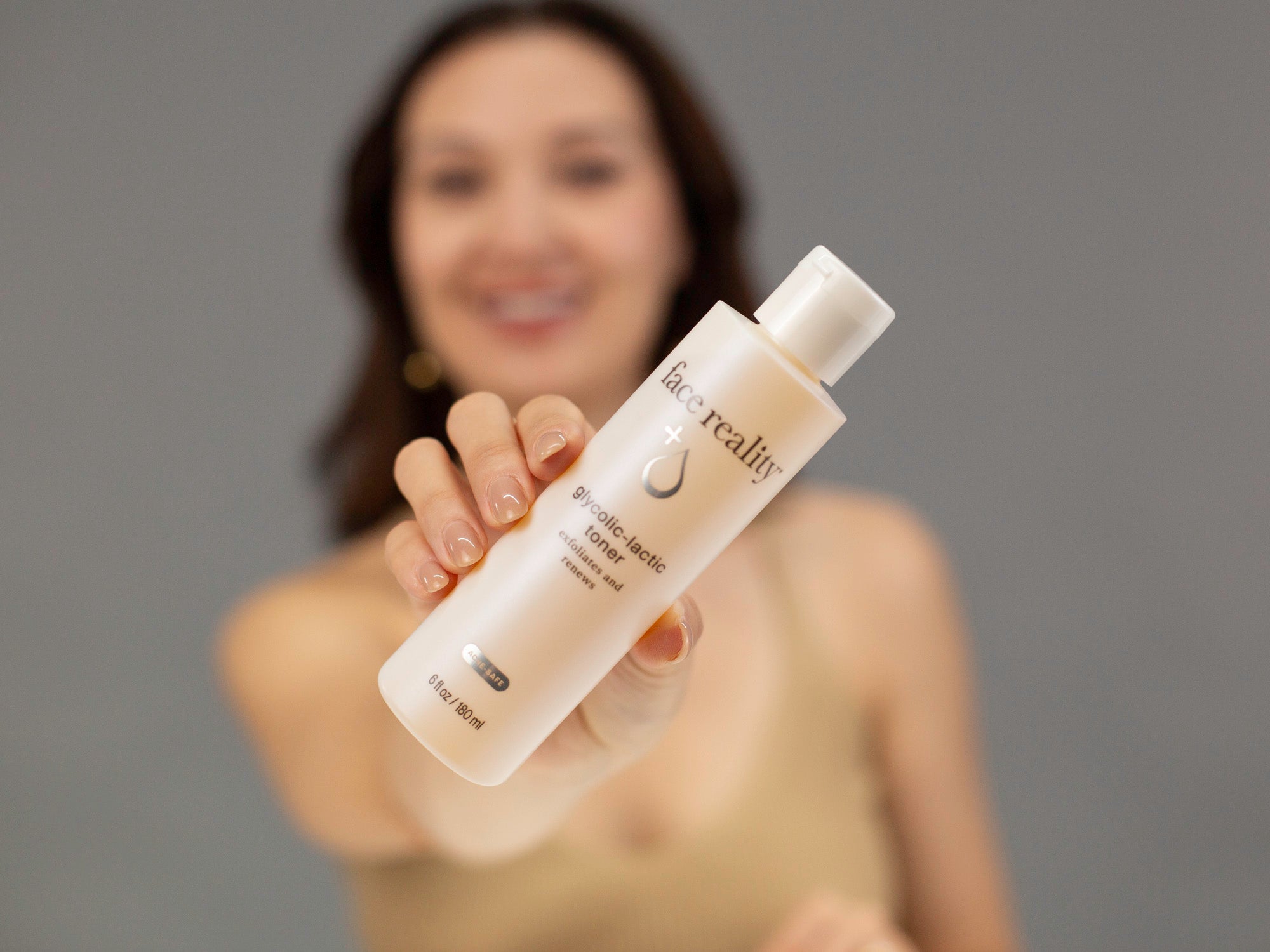 Laziza from LAZ Skincare demonstrating the texture and application of Face Reality Glycolic-Lactic Toner on her hand