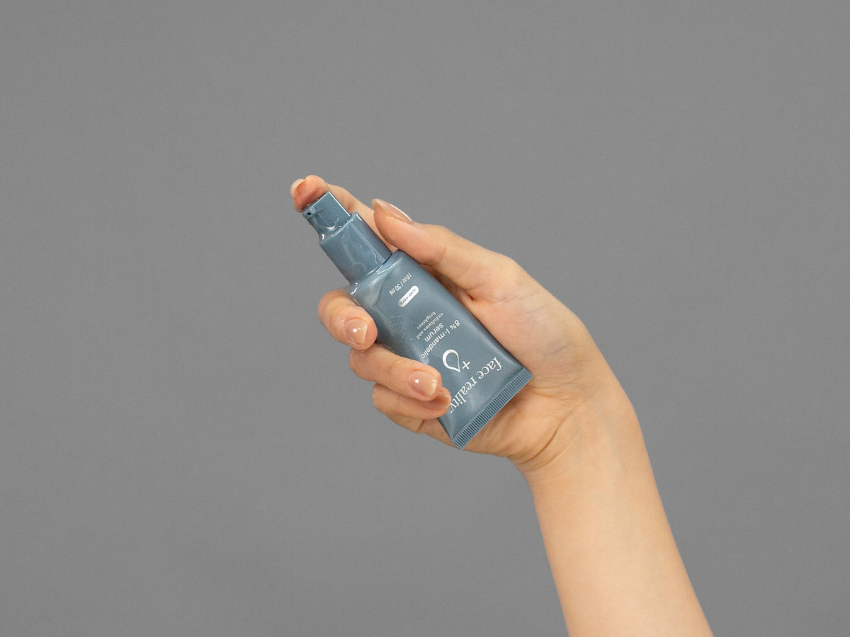 Closeup of Laziza from LAZ Skincare holding up a bottle of Face Reality Mandelic Serum