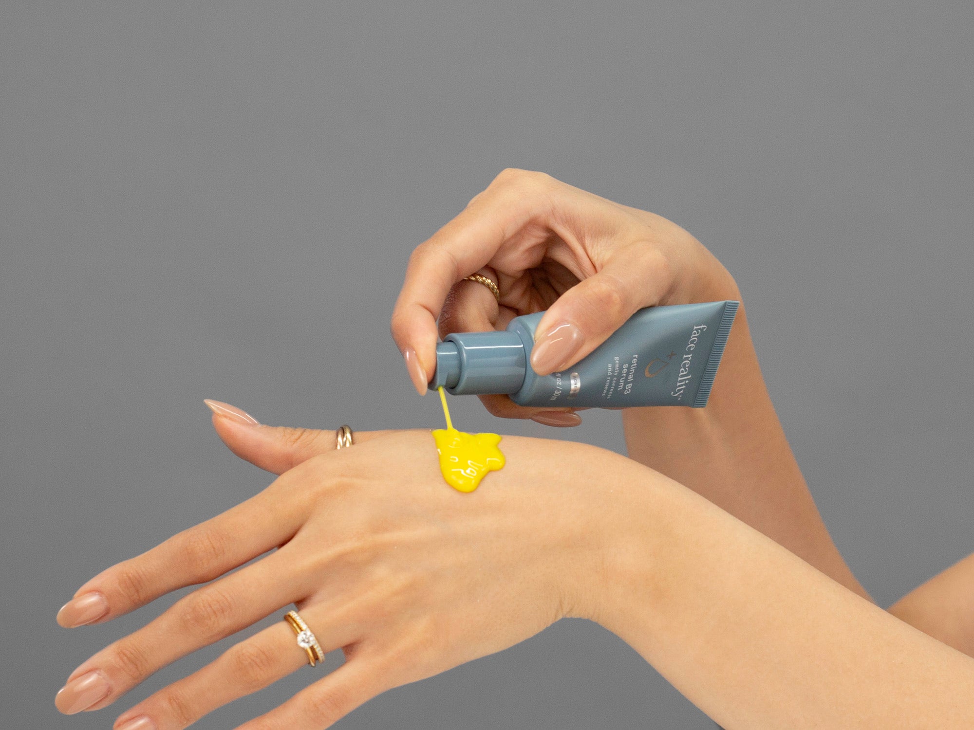 Laziza from LAZ Skincare demonstrating the texture and application of Face Reality Retinal B3 Serum on her hand