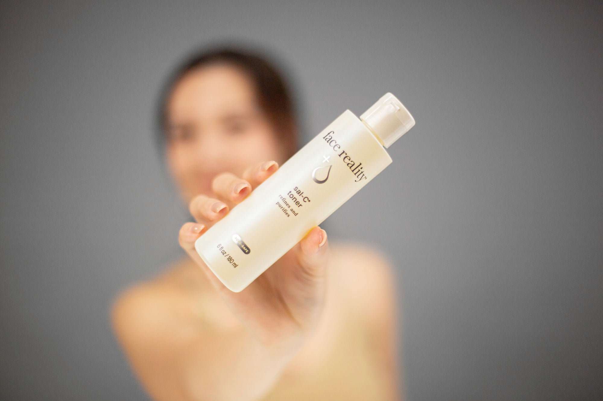 Laziza from LAZ Skincare demonstrating the texture and application of Face Reality Sal-C Toner on her hand