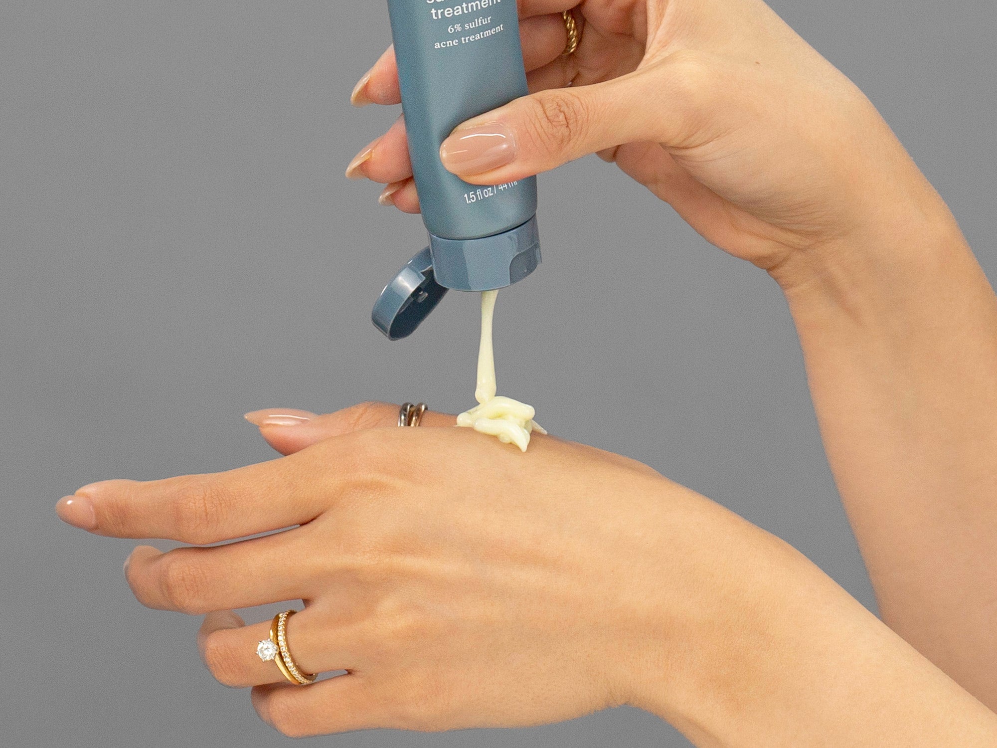 Laziza from LAZ Skincare demonstrating the texture and application of Face Reality Sulfur Spot Treatment on her hand
