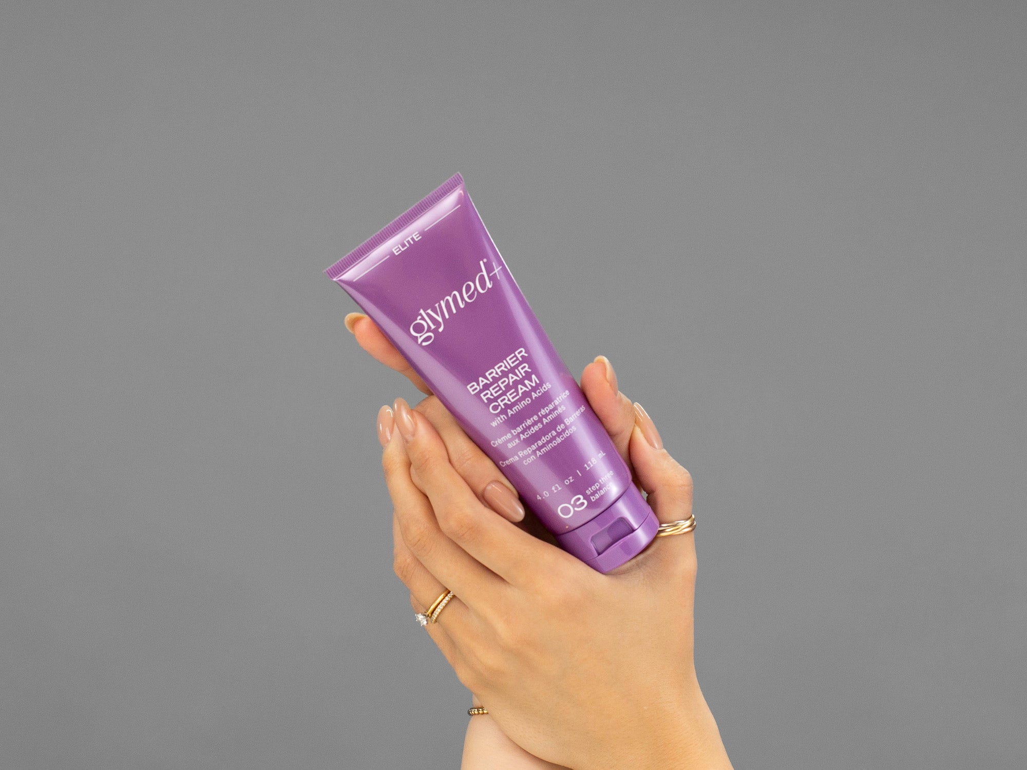 Closeup of Laziza from LAZ Skincare holding a tube of GlyMed Barrier Repair Cream in her hands
