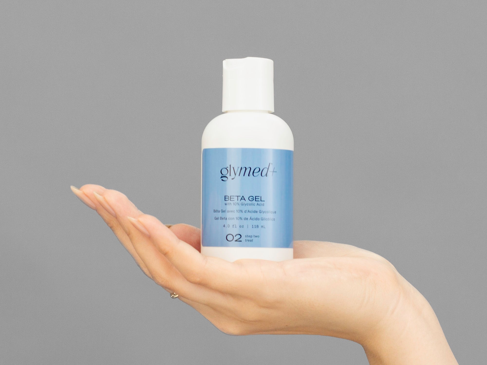 Closeup of Laziza from LAZ Skincare holding up a bottle of GlyMed Beta Gel