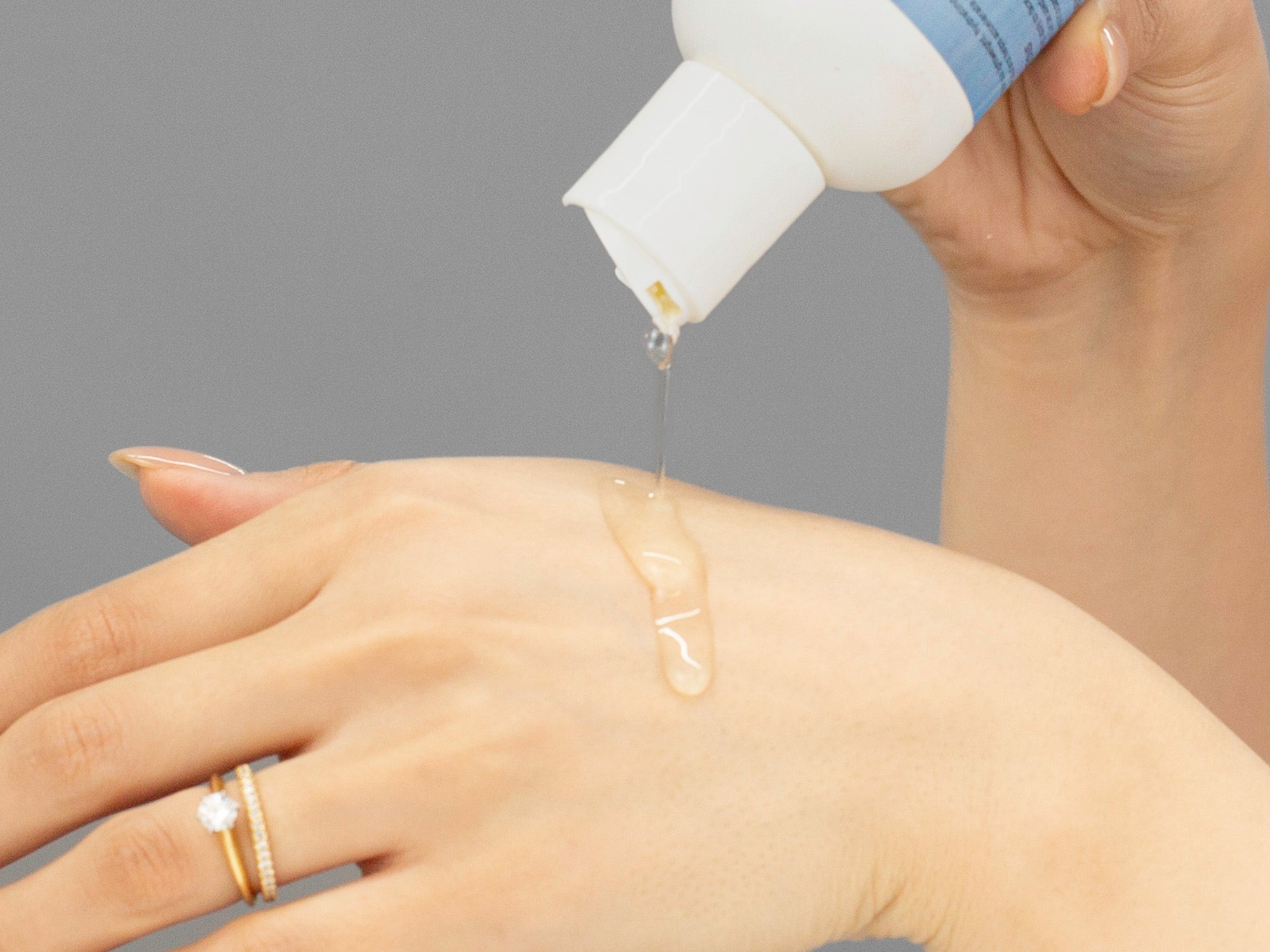 Laziza from LAZ Skincare demonstrating the texture and application of GlyMed Beta Gel on her hand