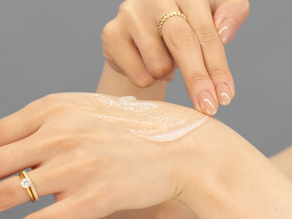Laziza from LAZ Skincare demonstrating the texture and application of GlyMed Exfoliating Cleanser on her hand