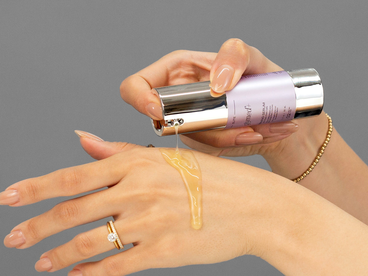 Laziza from LAZ Skincare demonstrating the texture and application of GlyMed Firming Serum on her hand