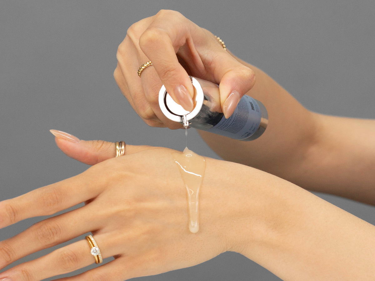 Laziza from LAZ Skincare demonstrating the texture and application of GlyMed Hemp Age Delay Dew on her hand