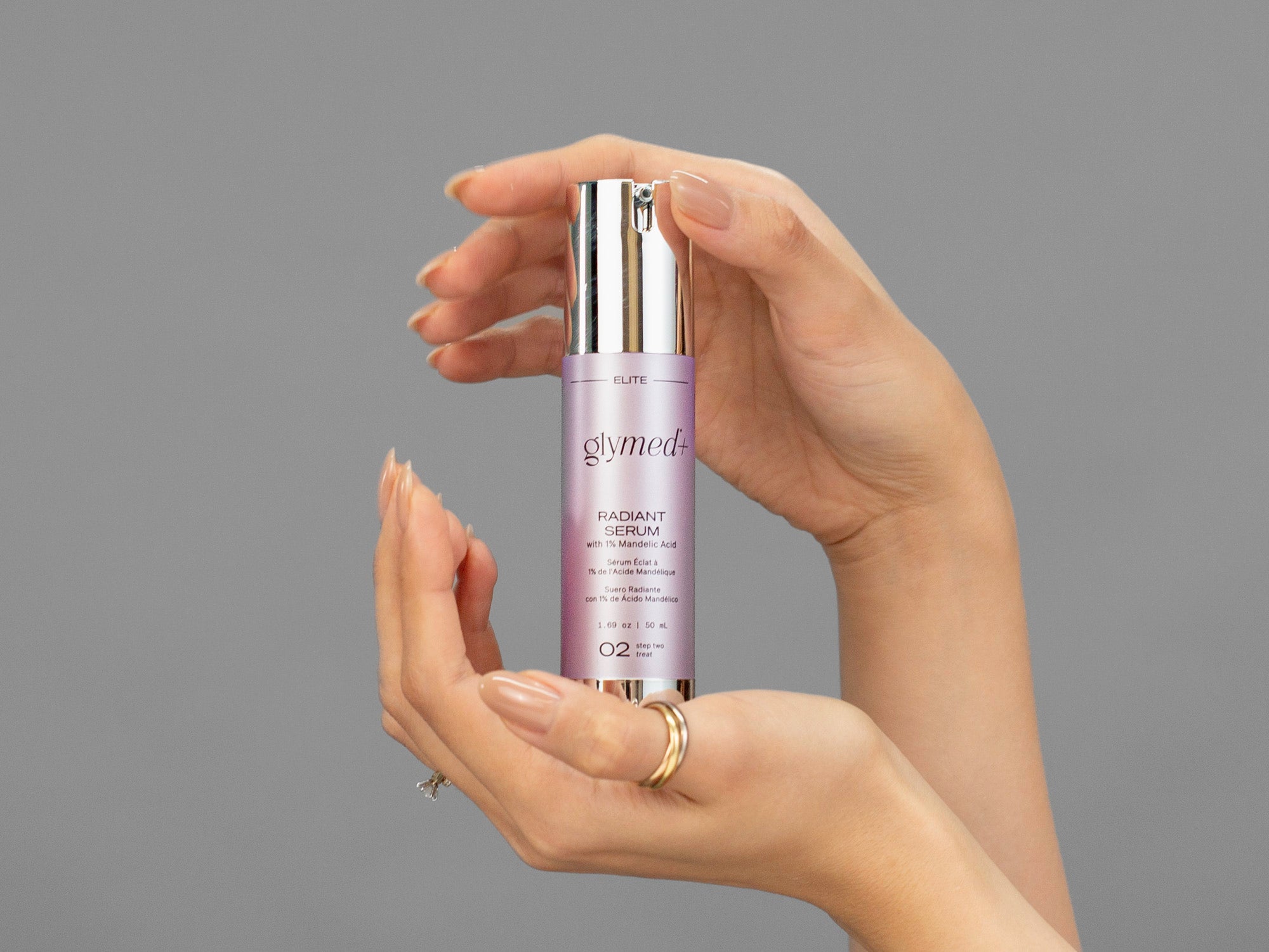Closeup of Laziza from LAZ Skincare holding up a bottle of GlyMed Radiant Serum